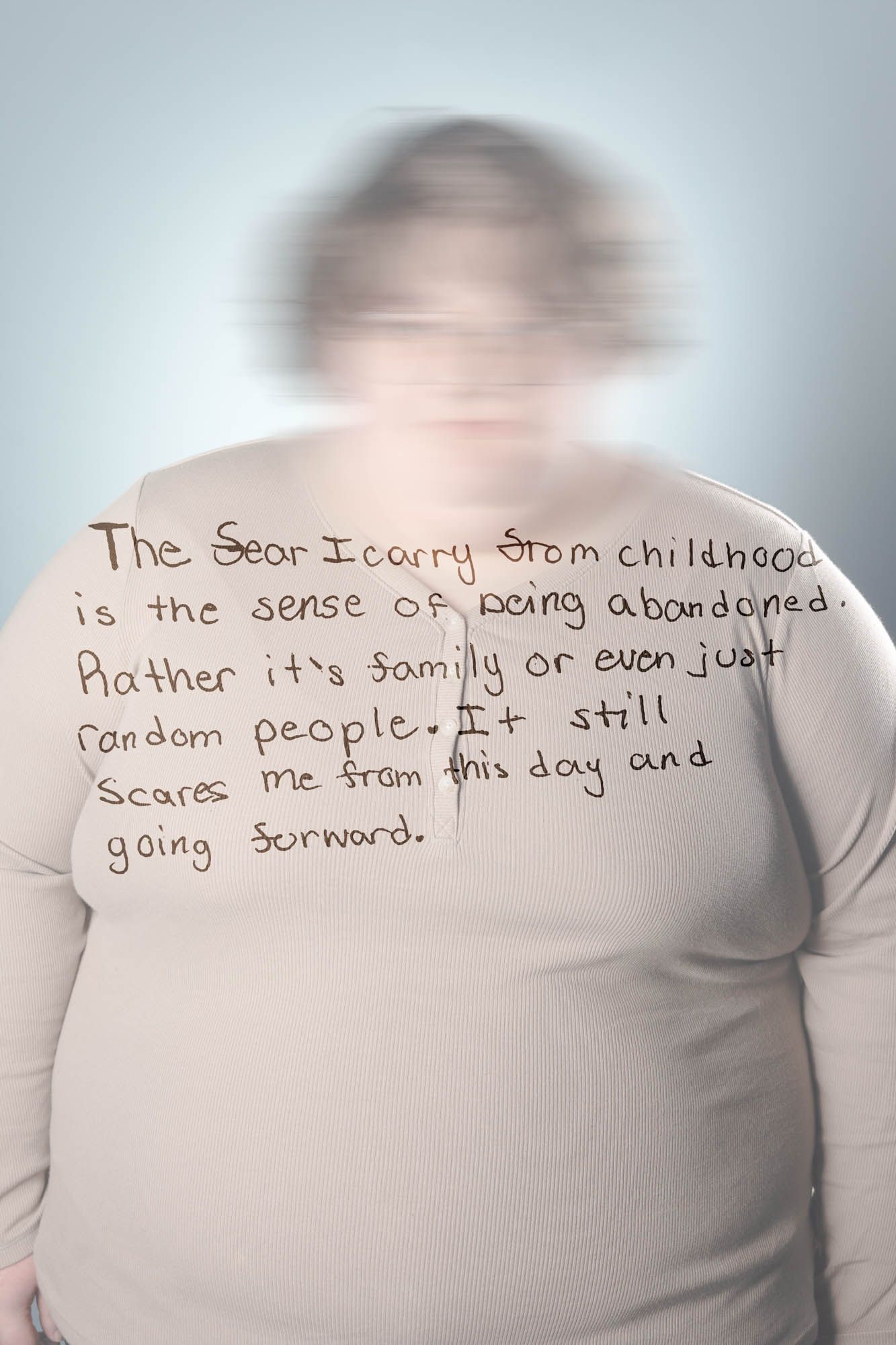 Blurred portrait of a heavy-set person with handwritten text about childhood fear of abandonment.