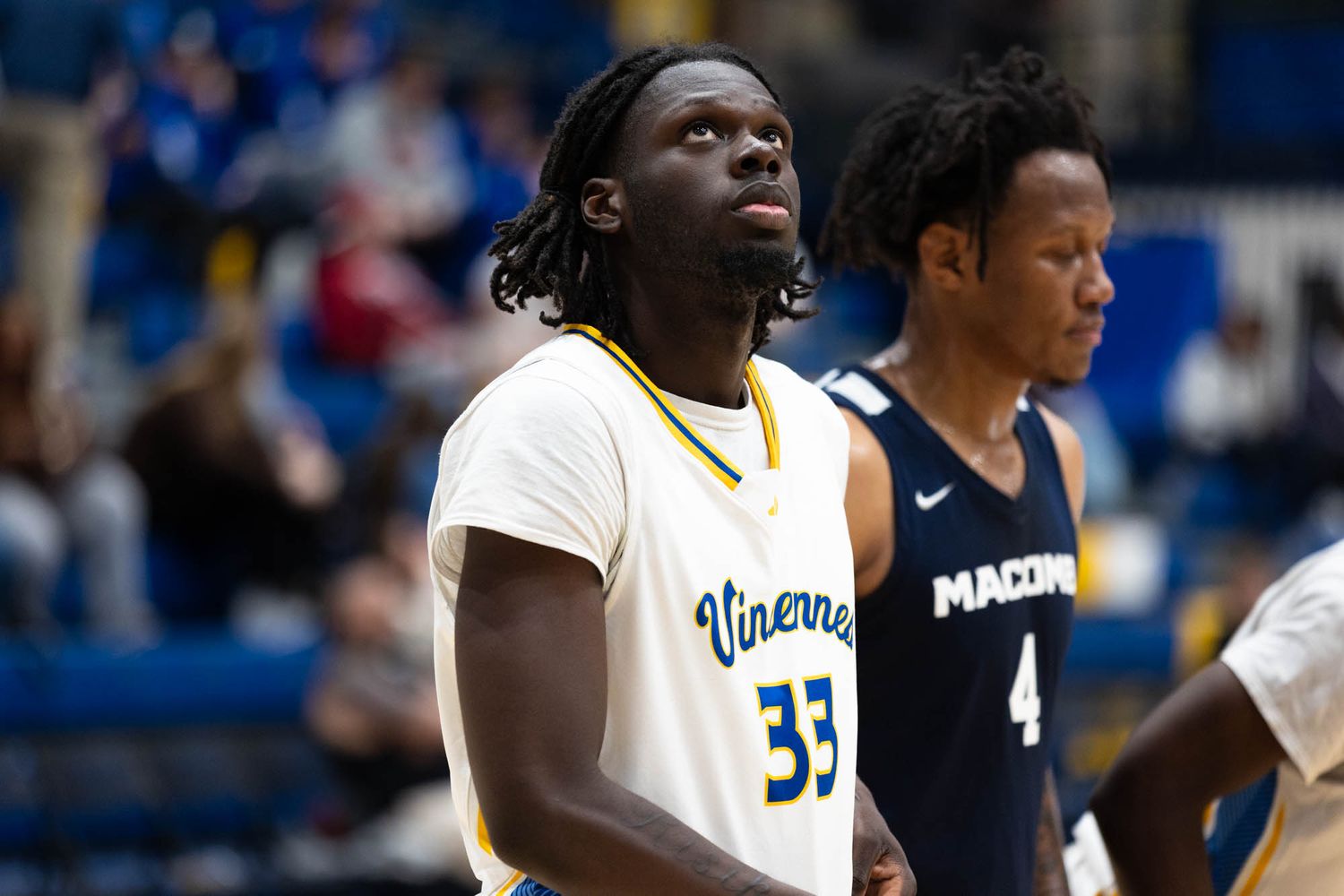 Vincennes University basketball player number 33 stands on court during a game.