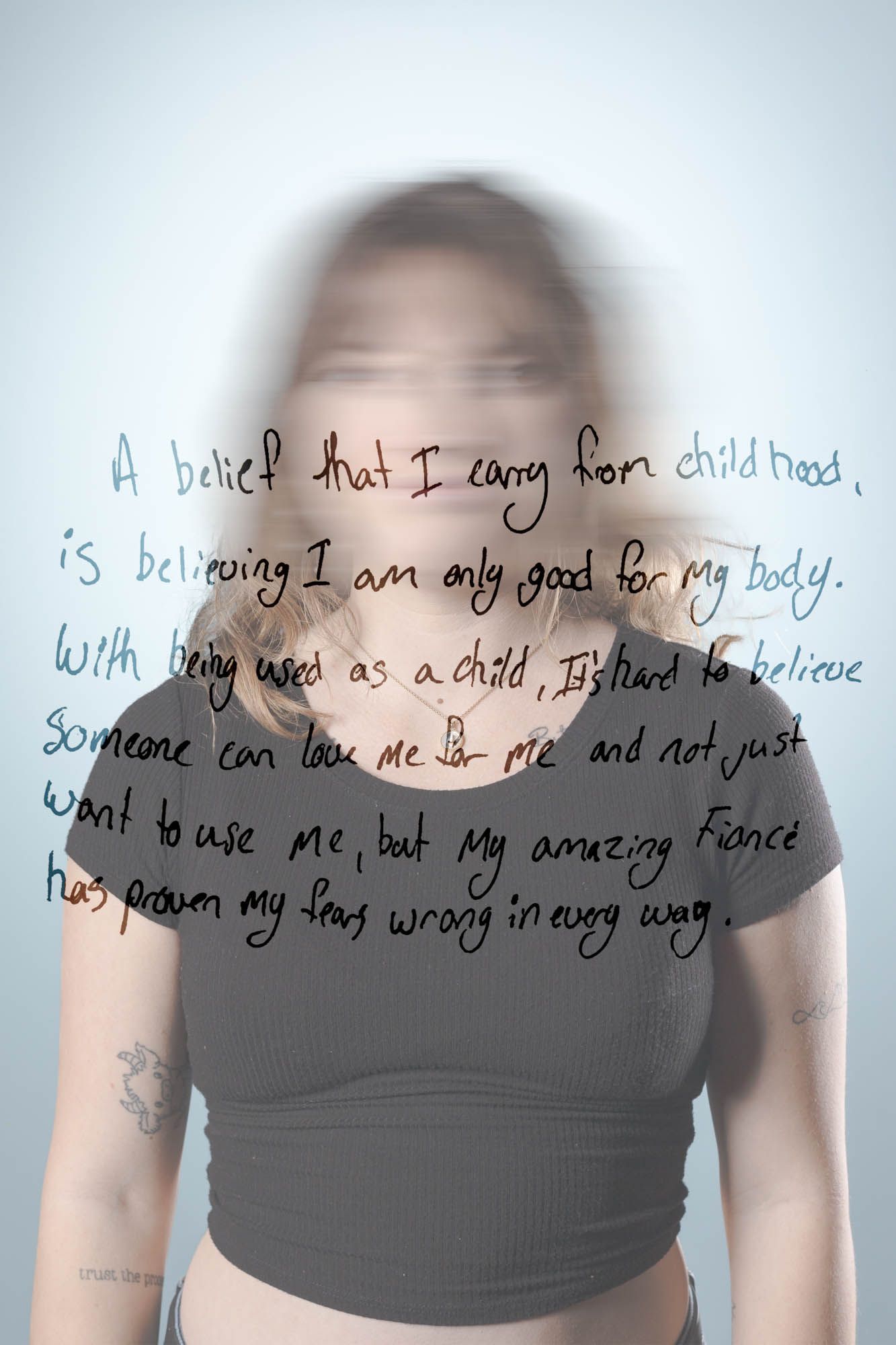 Young woman with blurred face and tattoos with handwritten text overlay about childhood beliefs and self-worth.