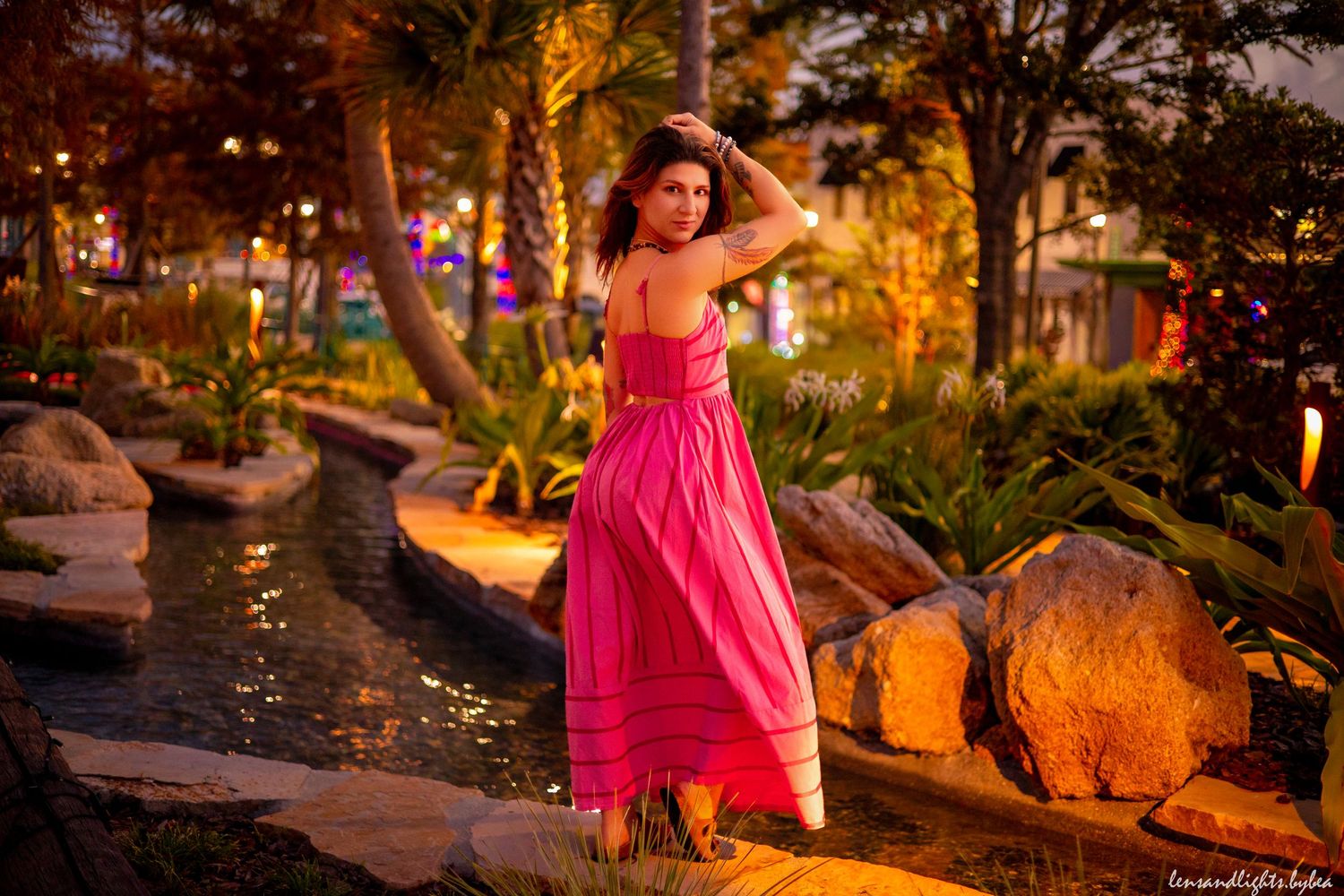 Garden photoshoot at night with warm lighting and tropical plants.