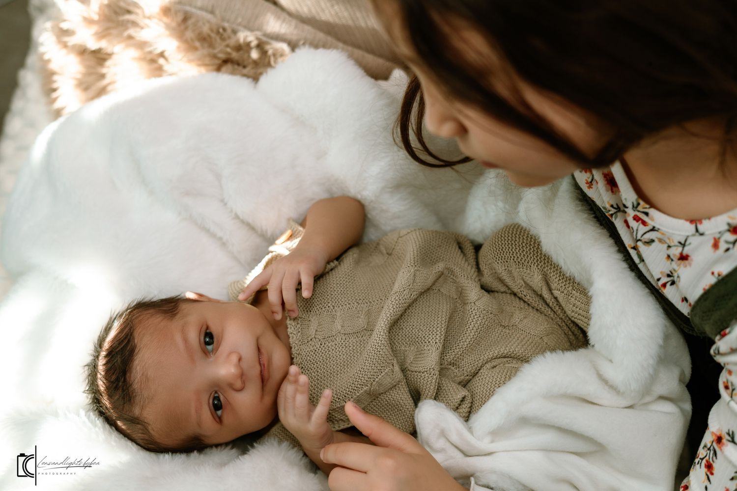 A tender newborn photography session showing intimate moments between parent and baby in soft natural light.