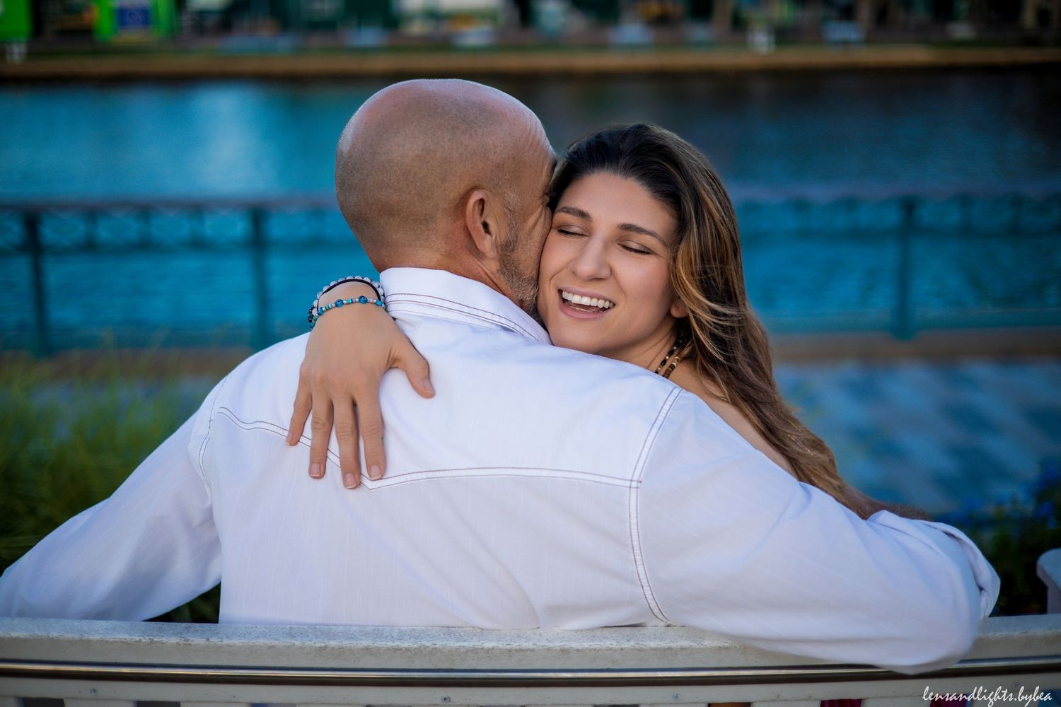 Romantic couple photos by water with blue tones and natural lighting.