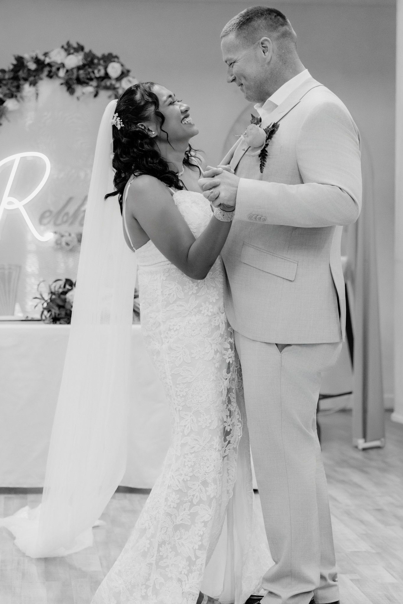 Bride and groom share an intimate moment during their outdoor wedding ceremony in elegant white attire.