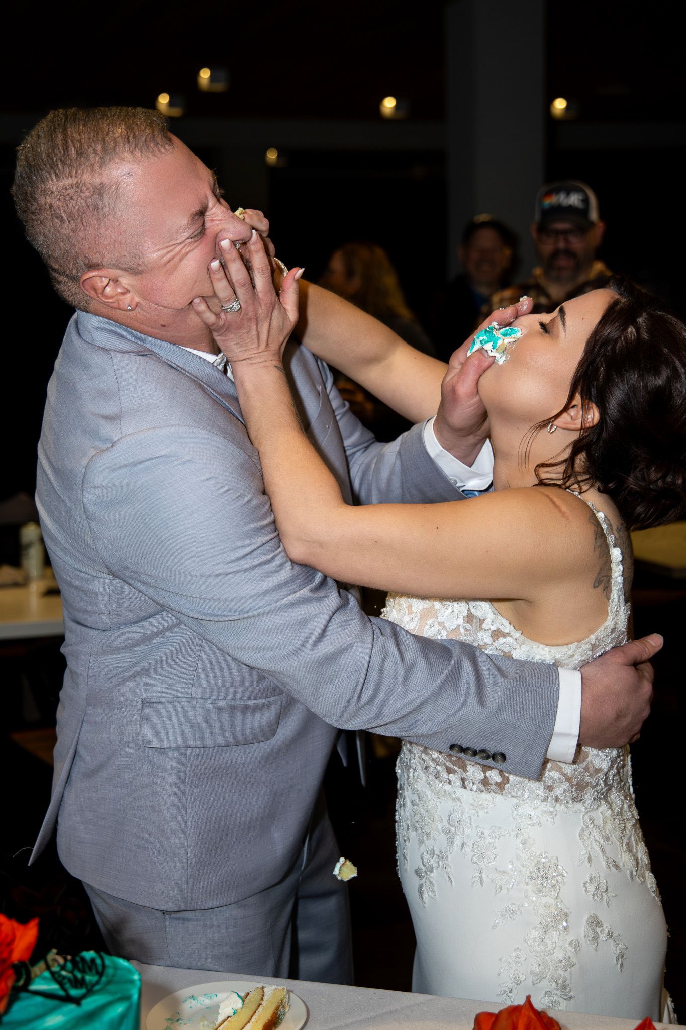 A couple in wedding attire share a playful moment during their first dance at their wedding reception.
