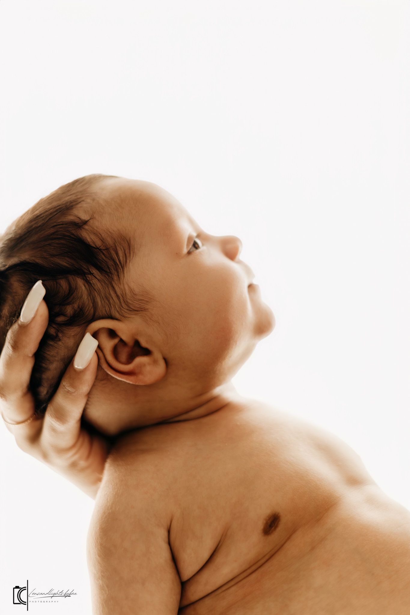 A sepia-toned artistic photo series showing a baby's head and neck from different angles against a white background.