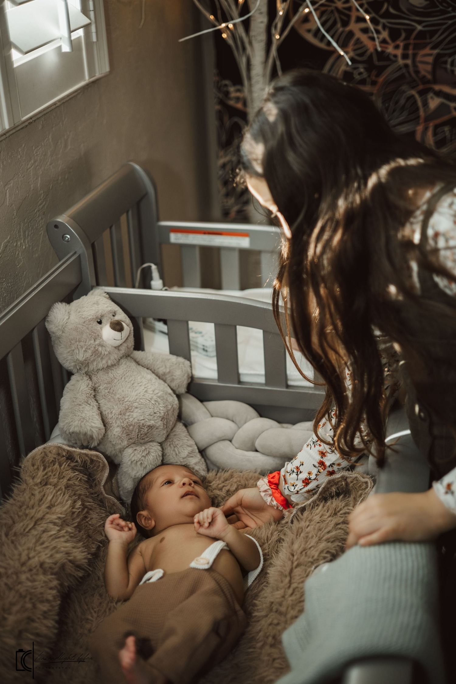 A cozy scene showing a teddy bear and blanket in dim lighting creating a peaceful atmosphere.