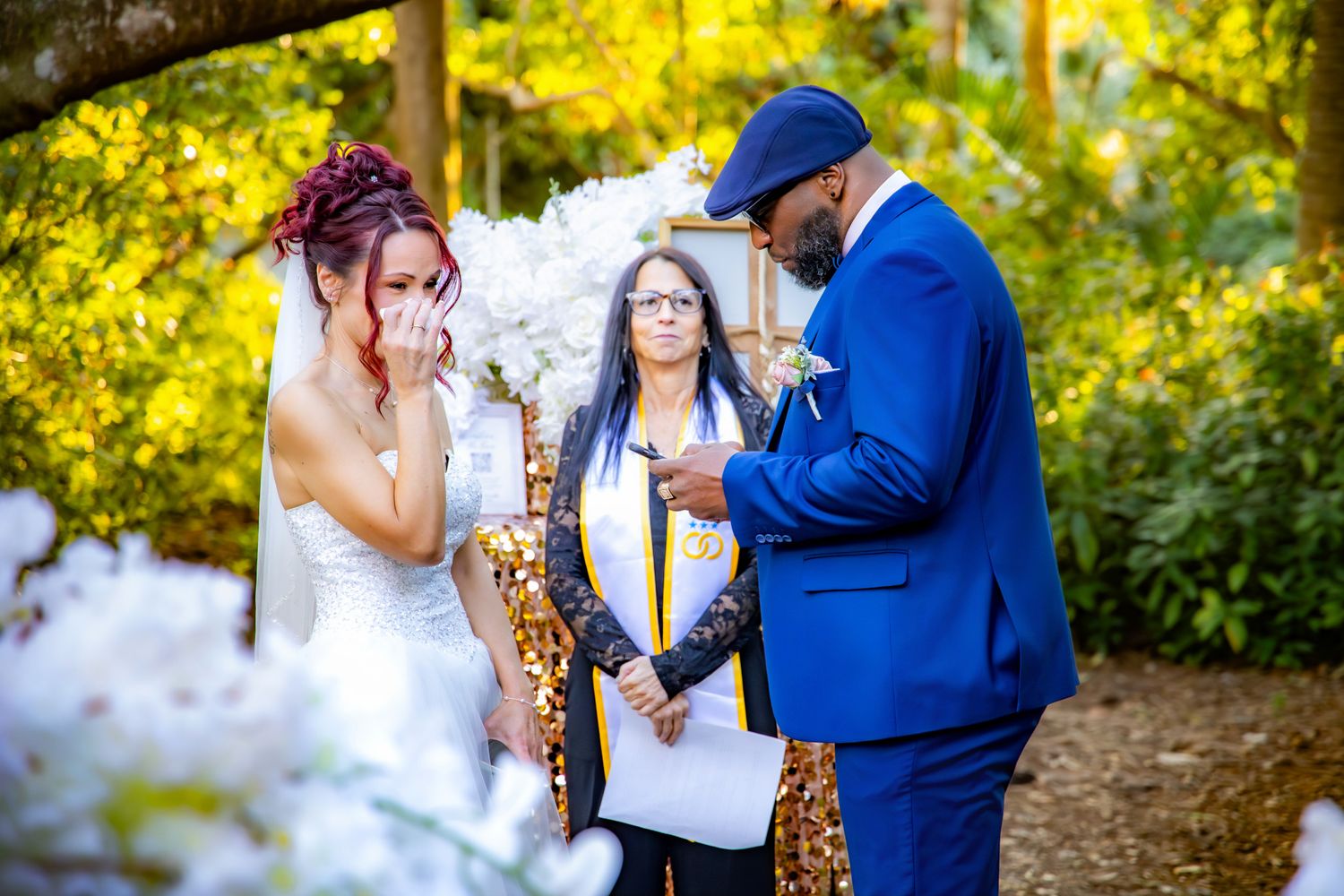 Couple sharing tender moments in a garden setting with vibrant yellow flowers in the background.
