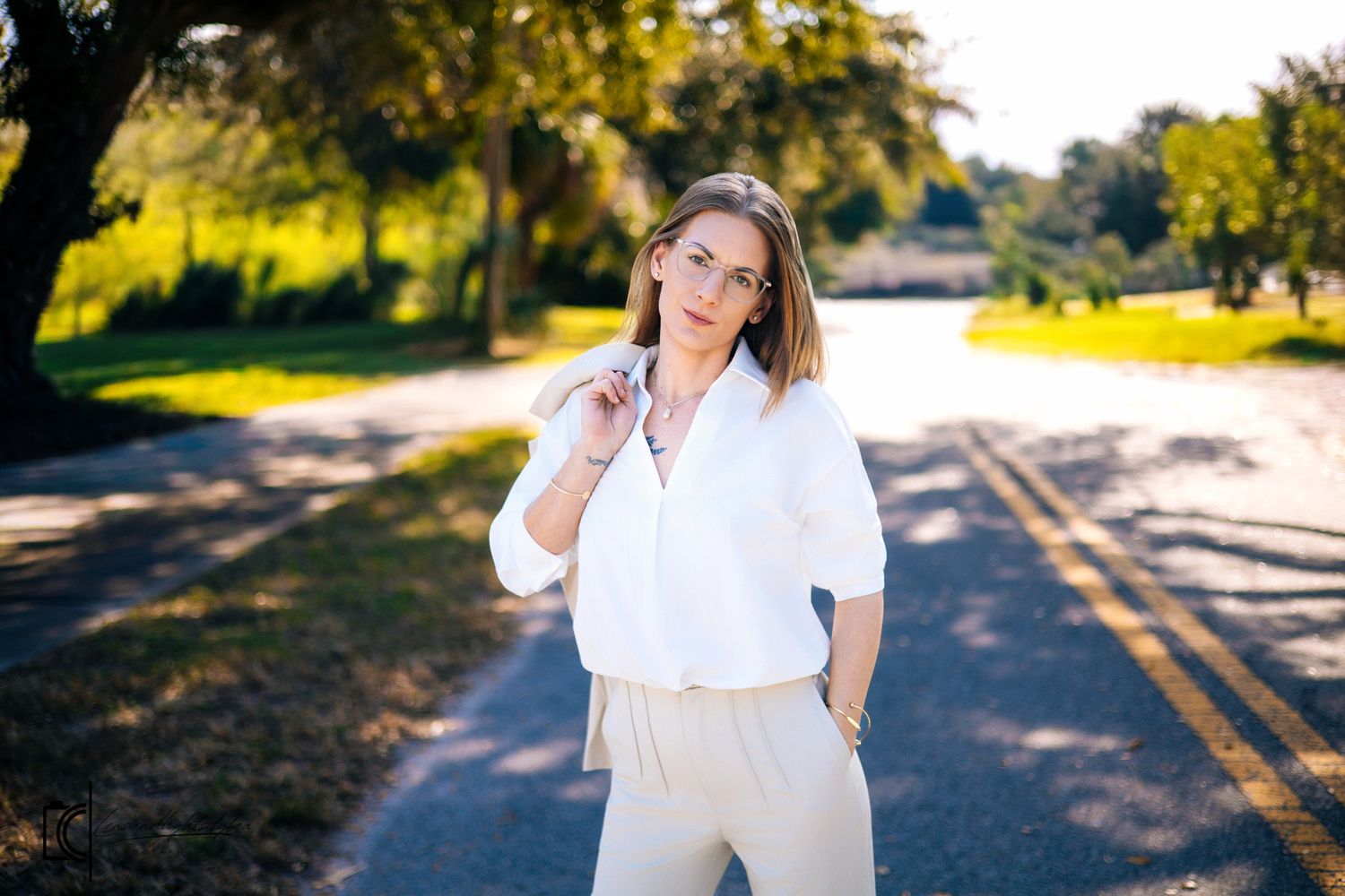 A series of outdoor maternity photos showing a woman in a white dress posing along a tree-lined path at sunset.