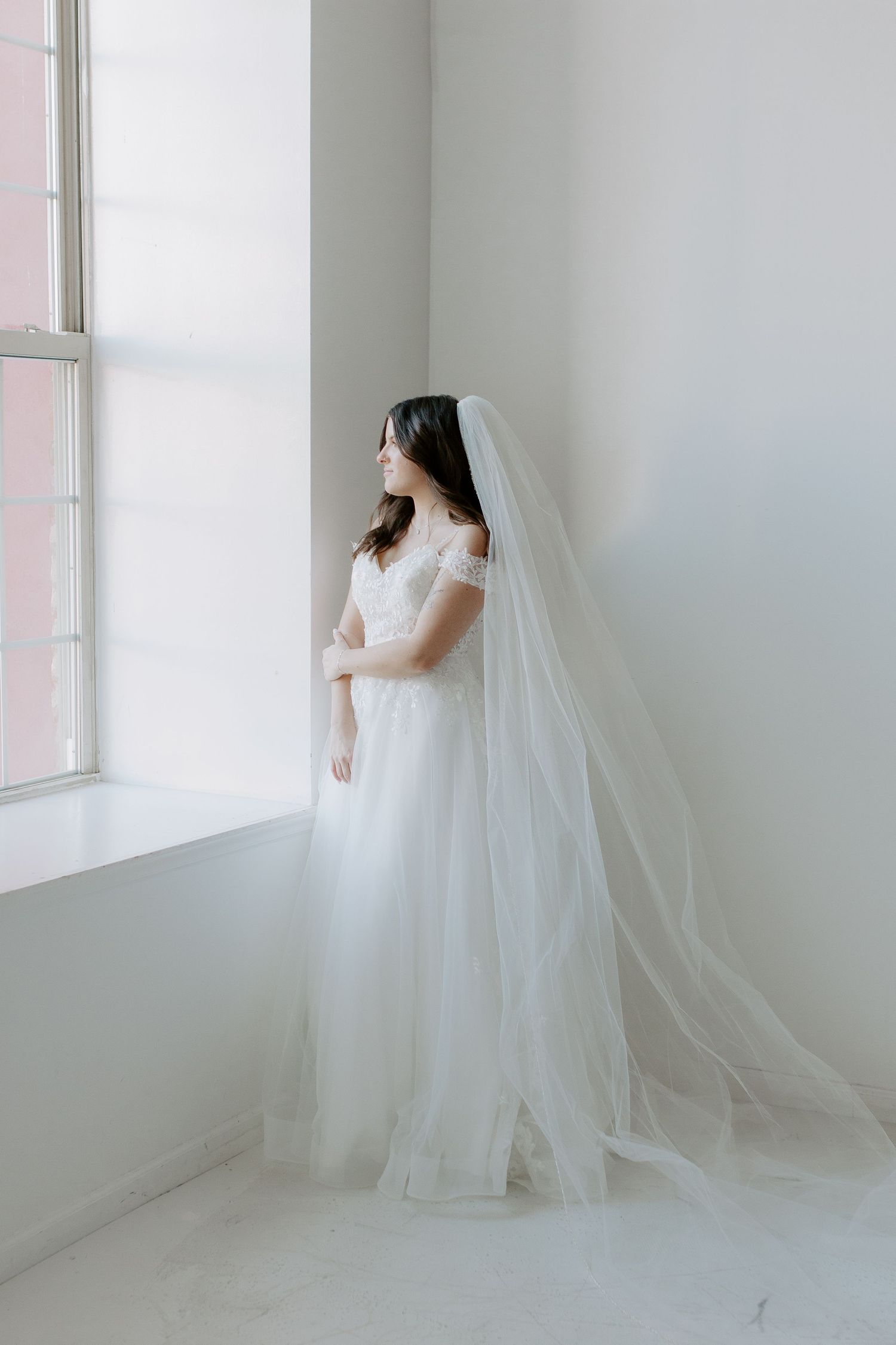 studio session of bride indoors with wedding dress on