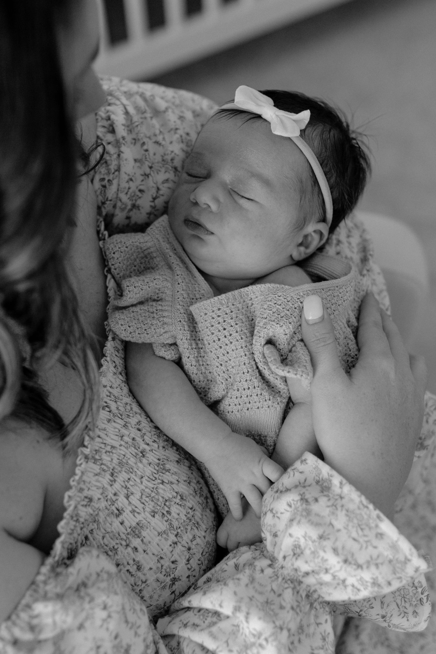 Mother gently holding her baby during a lifestyle newborn session