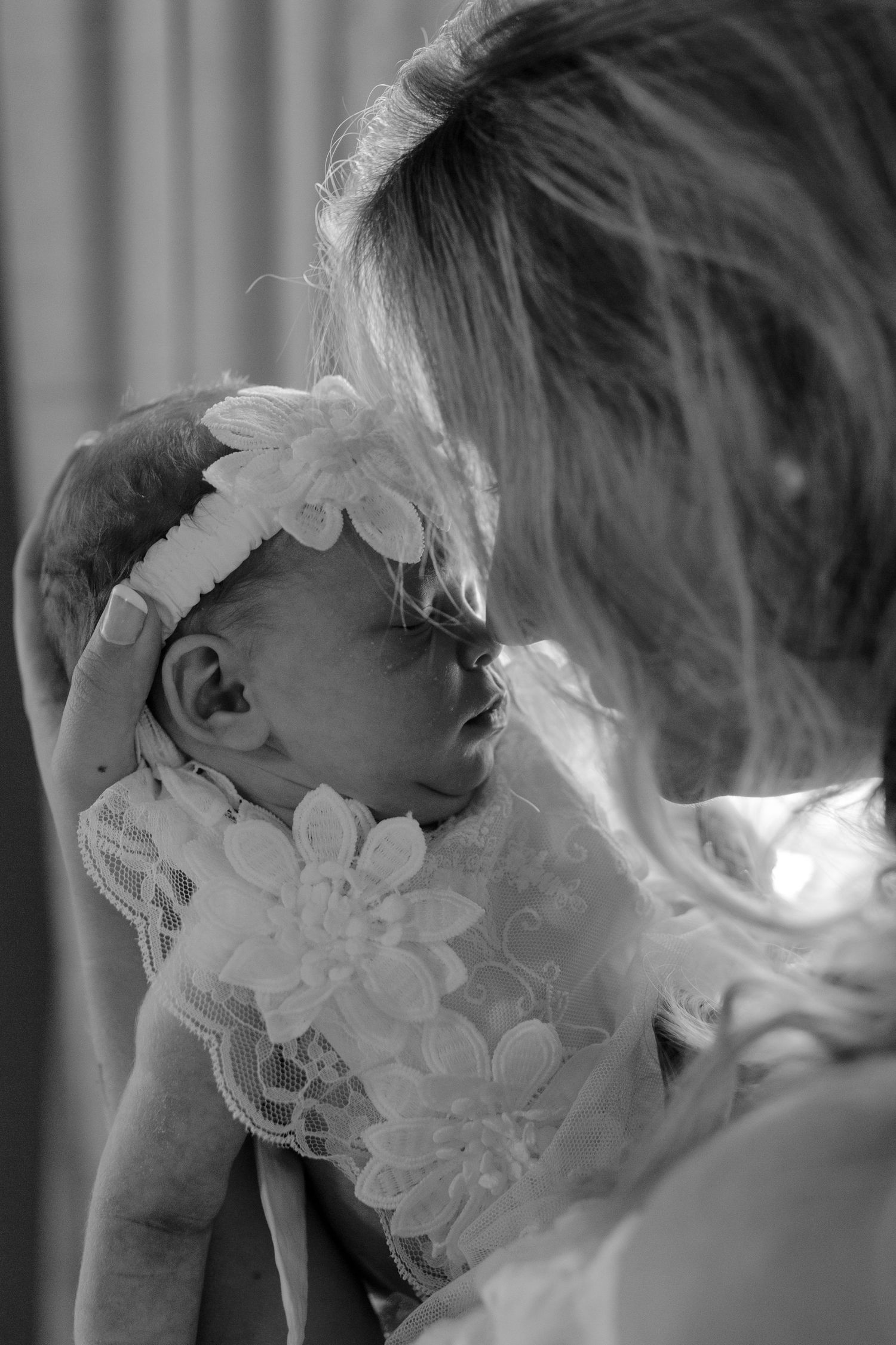 Mother gently holding her baby during a lifestyle newborn session