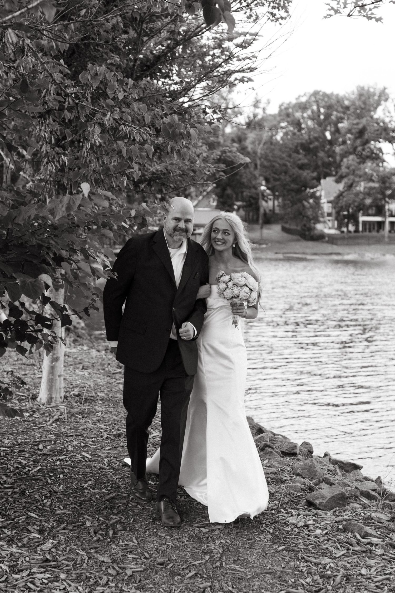 bride and father of the bride walking down the aisle together outside