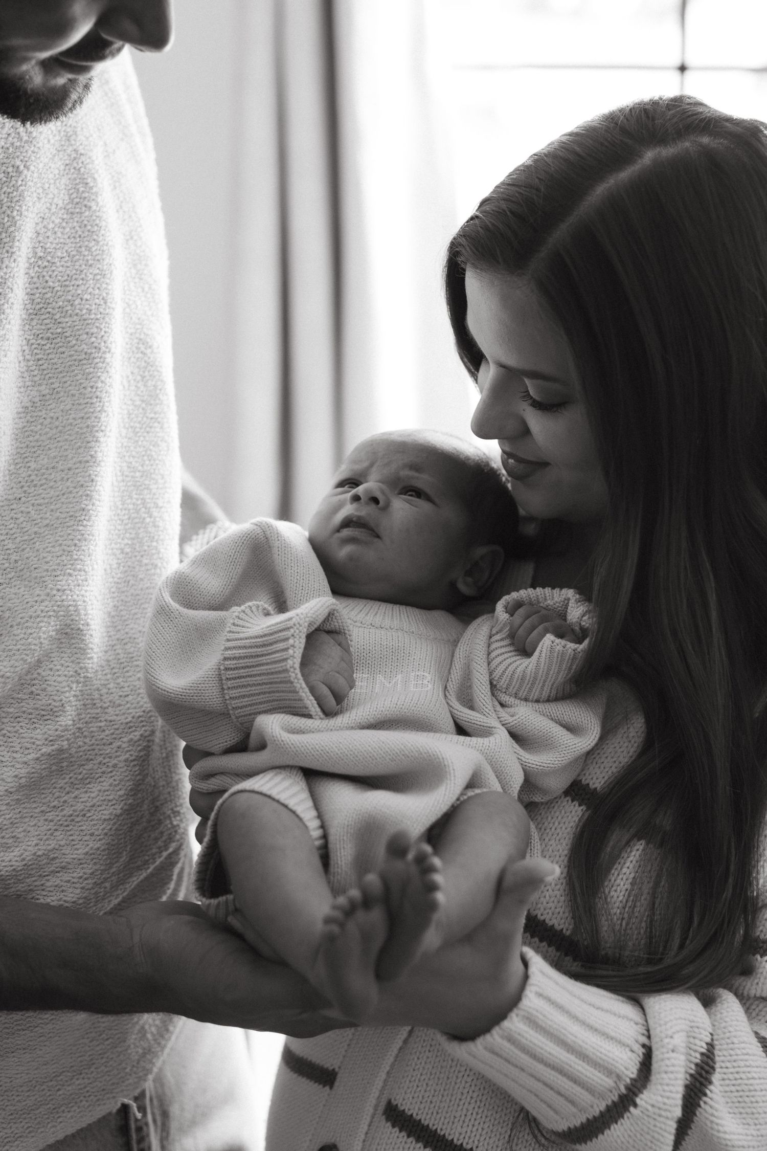 Parents holding their newborn baby during a newborn session