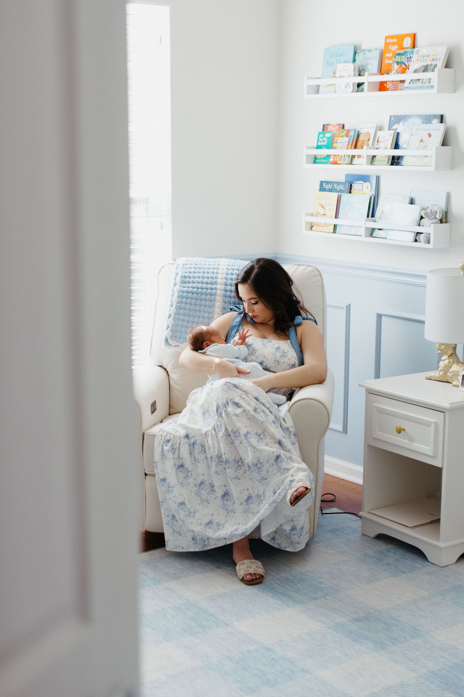 Mother gently holding her baby during a lifestyle newborn session in rock hill