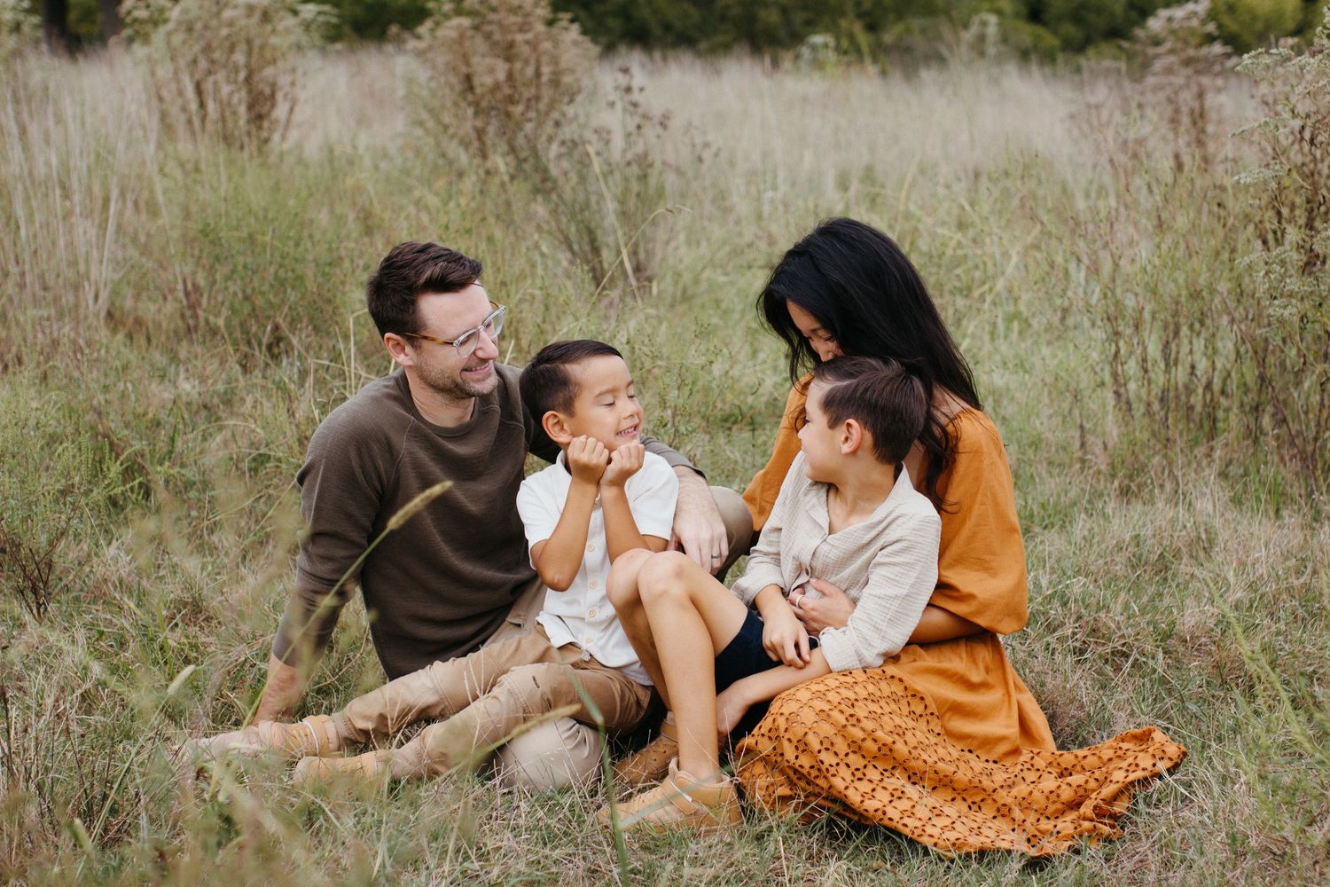 Family smiling together during an outdoor photography session