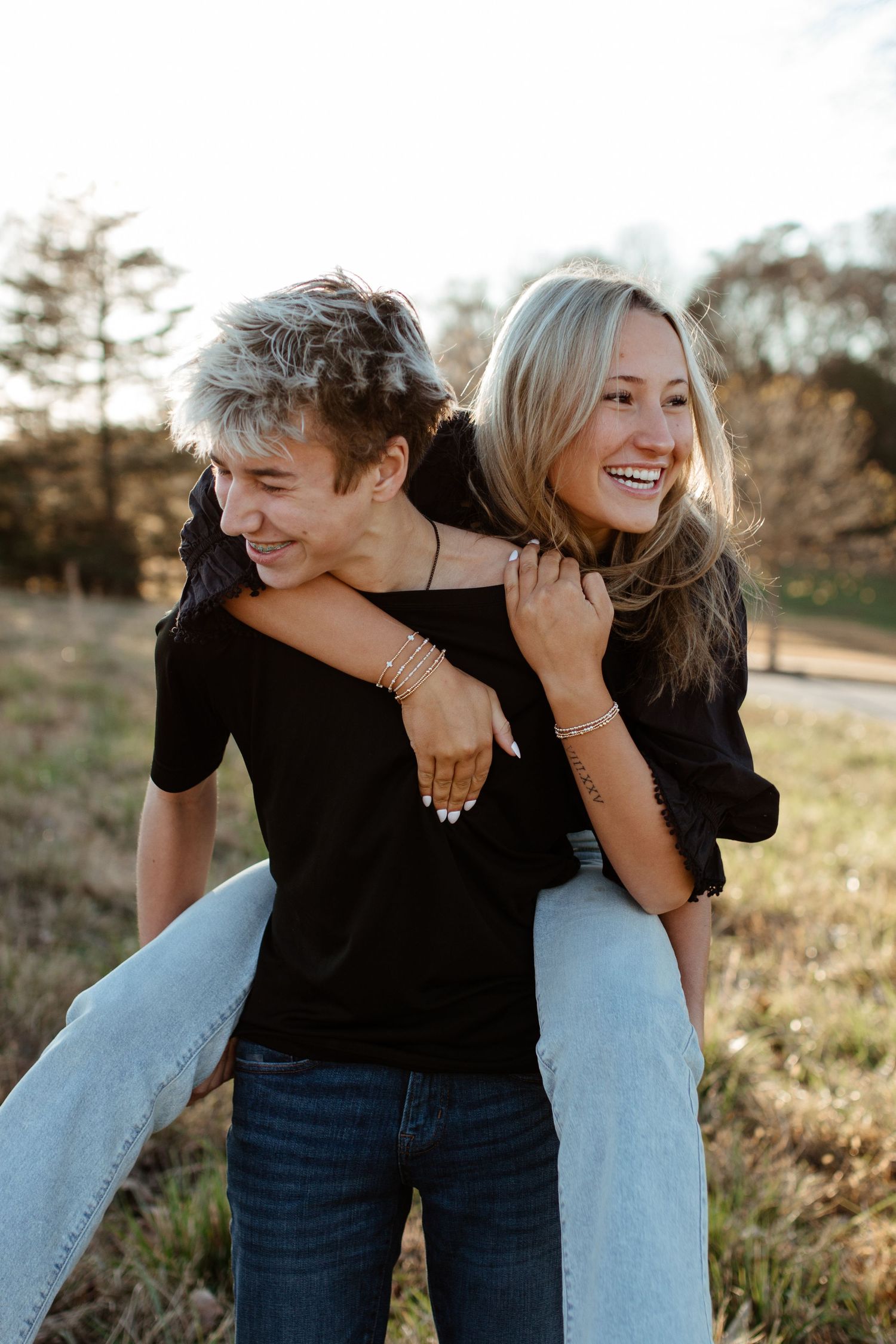 siblings sharing a moment laughing outside in a field in rock hill south carolina