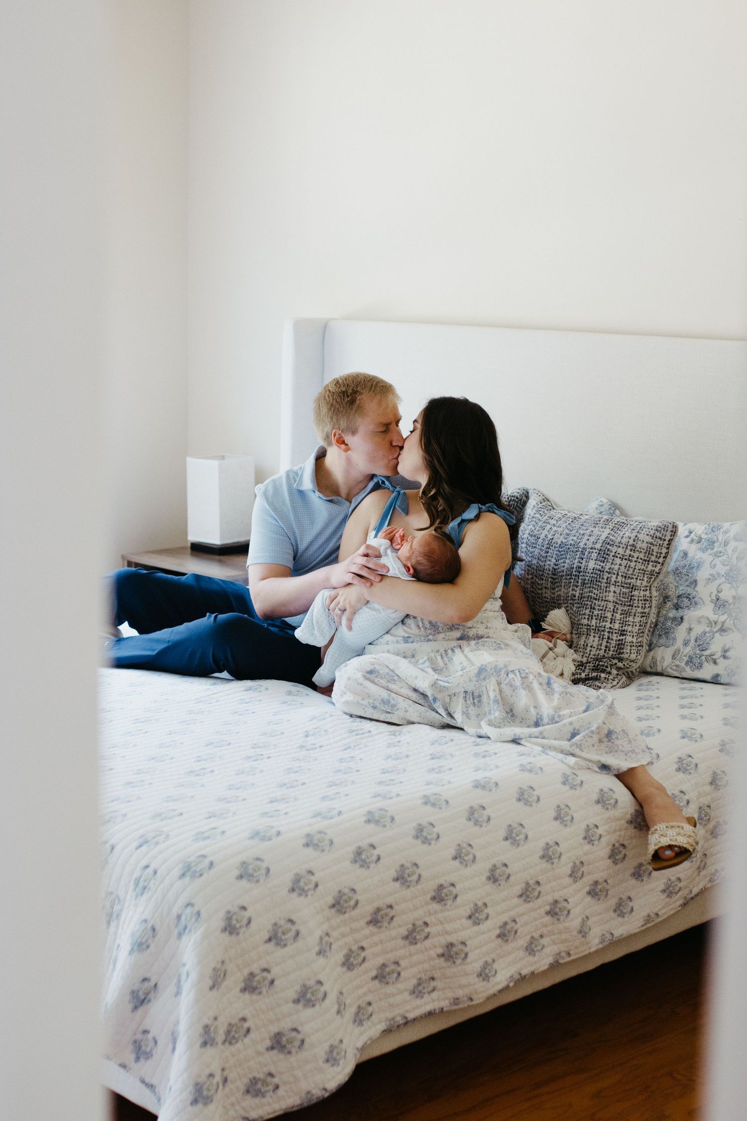 Parents holding their newborn baby during an in-home newborn session