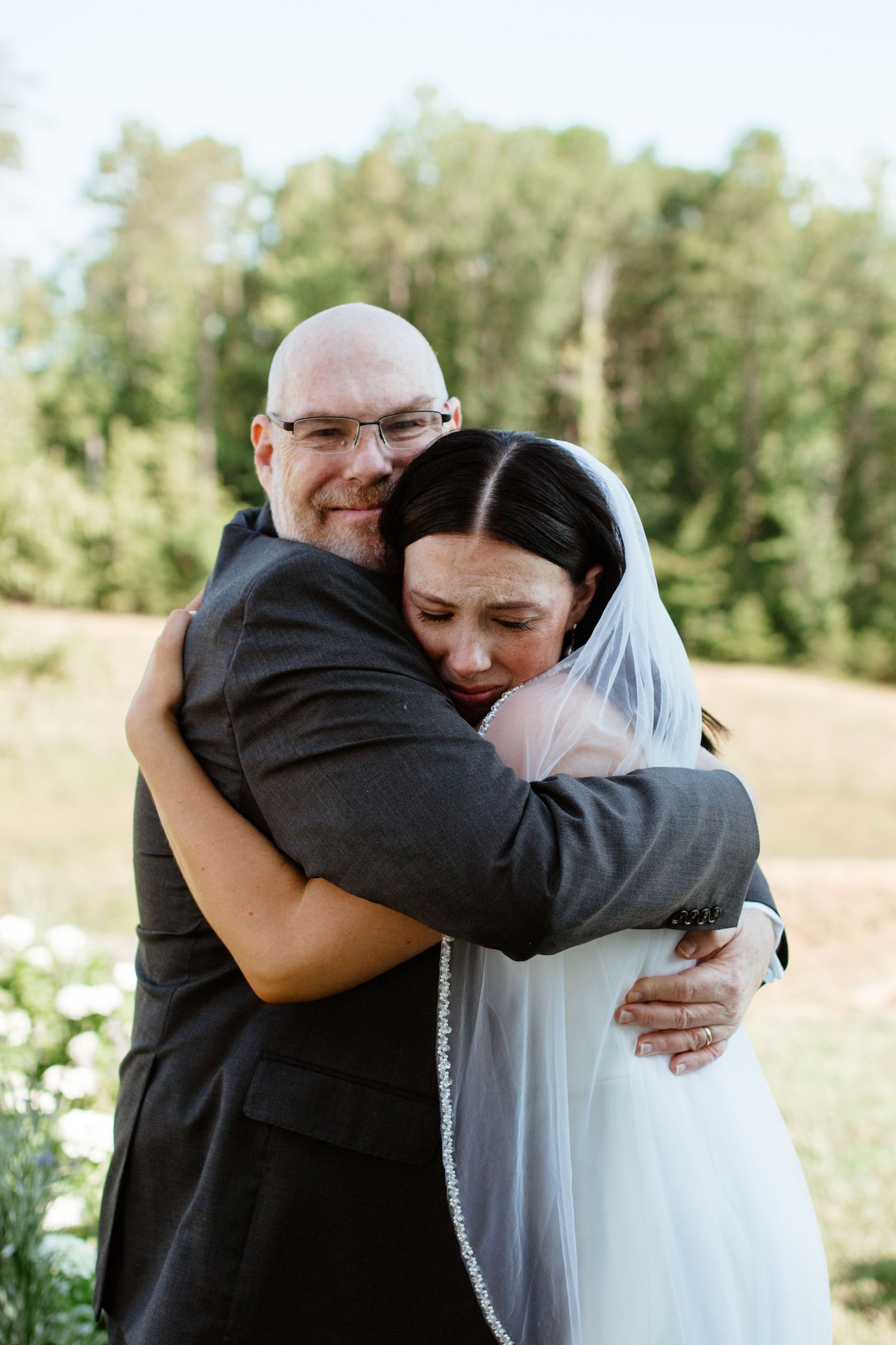 Father and bride sharing a tender moment before the ceremony