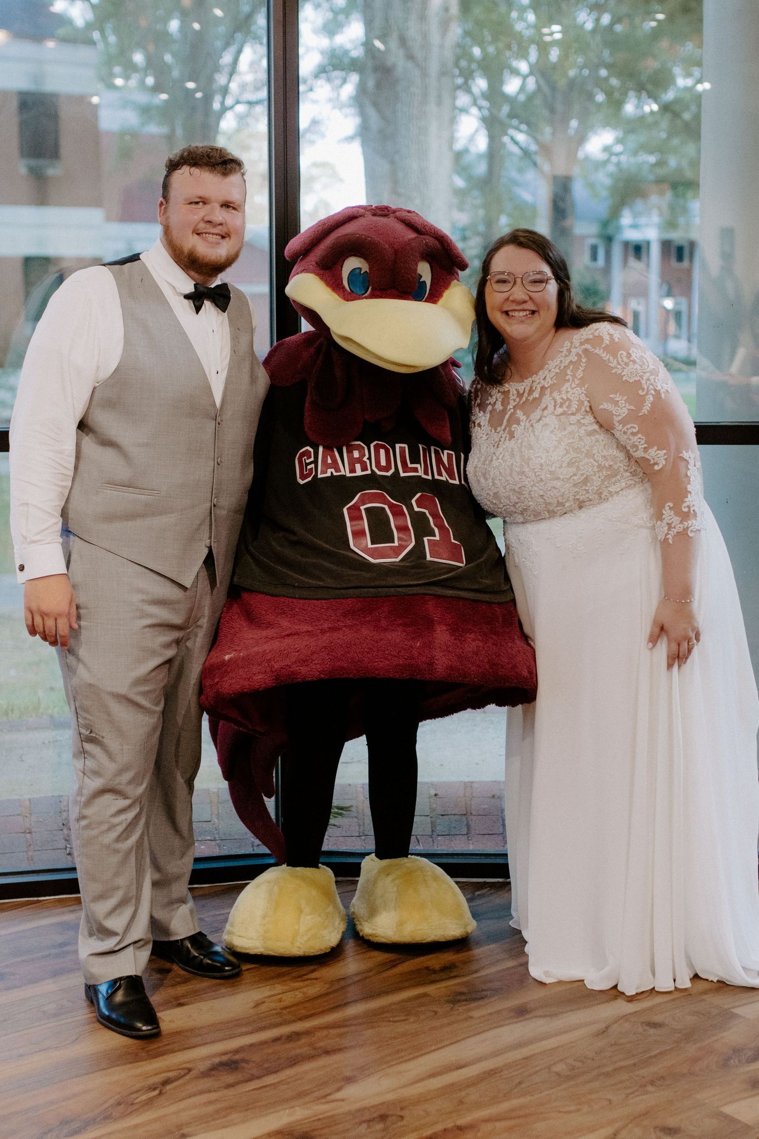 A couple celebrating their south carolina wedding with Gamecocks mascot