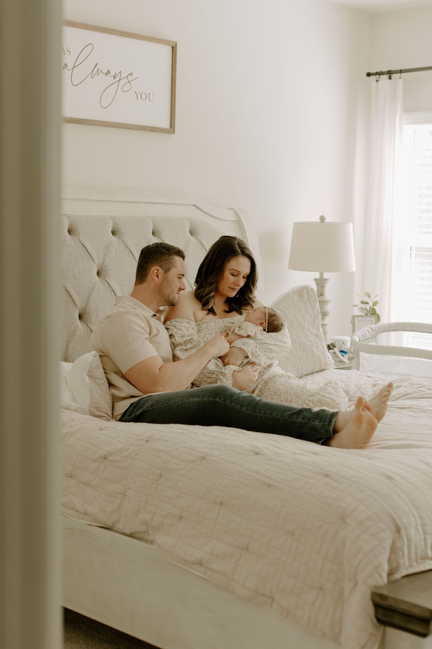 Parents holding their newborn baby during an in-home newborn session