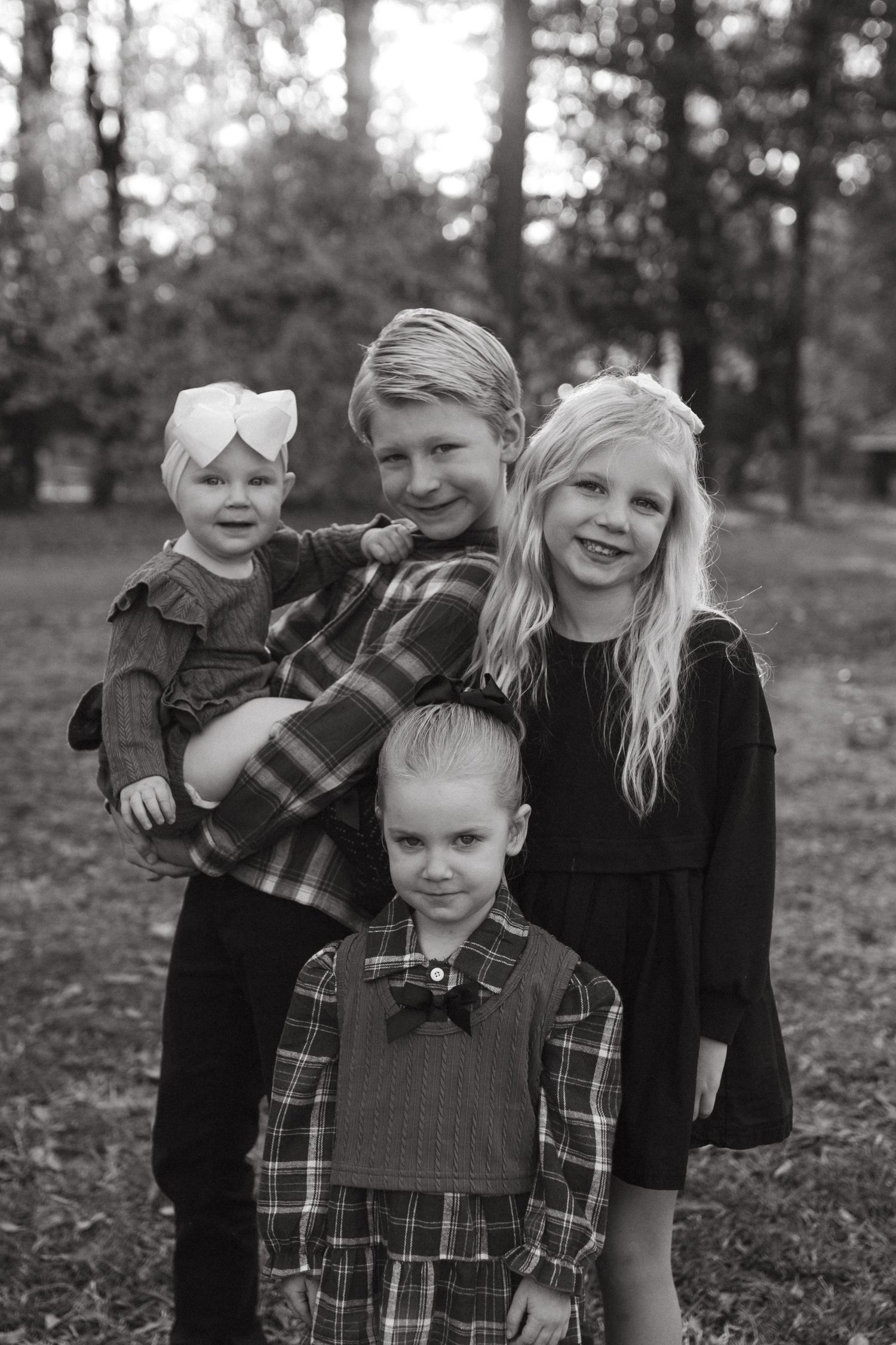 Siblings hugging and smiling together during a family session