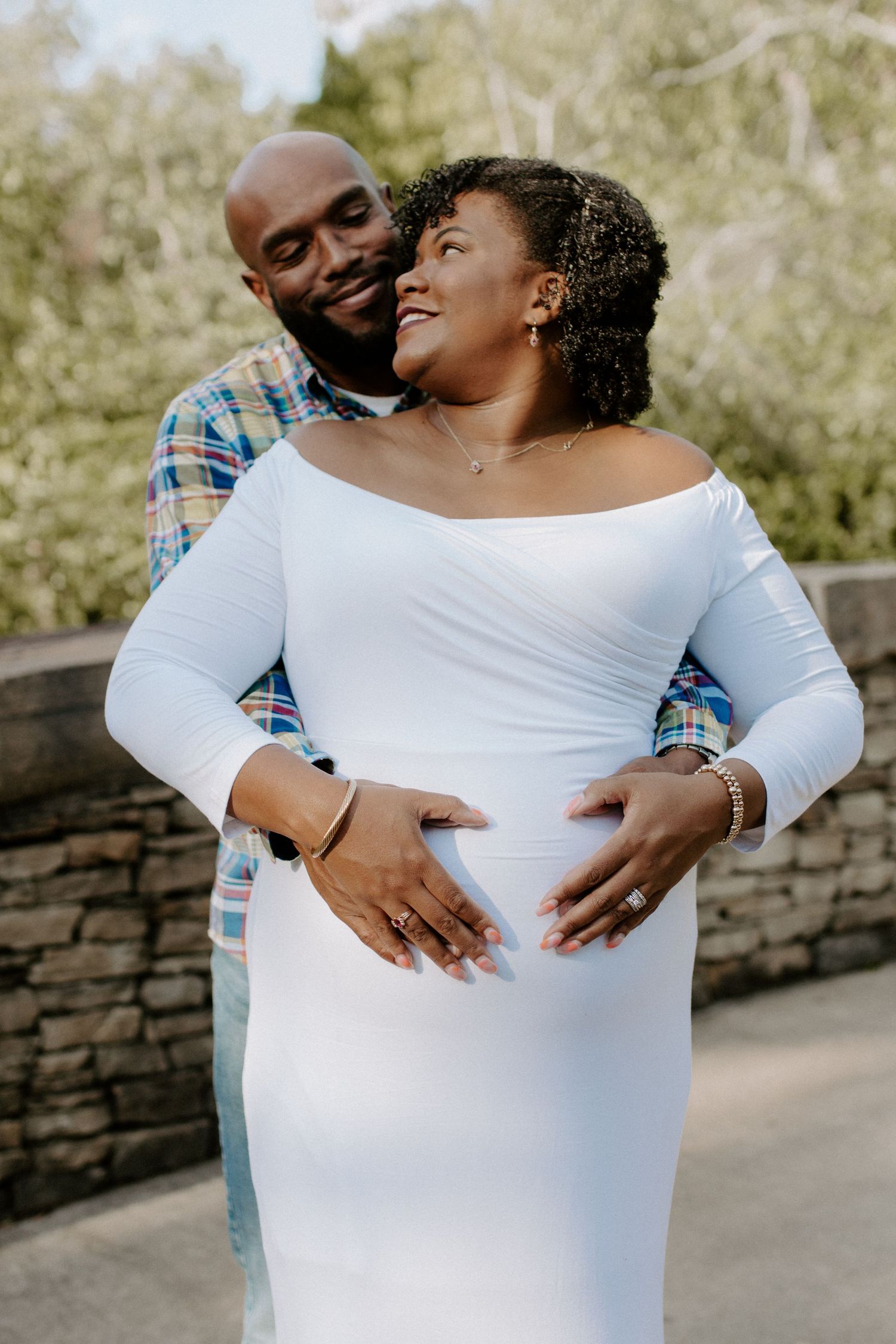 a mother-to-be cradling her baby bump during her charlotte nc maternity photoshoot