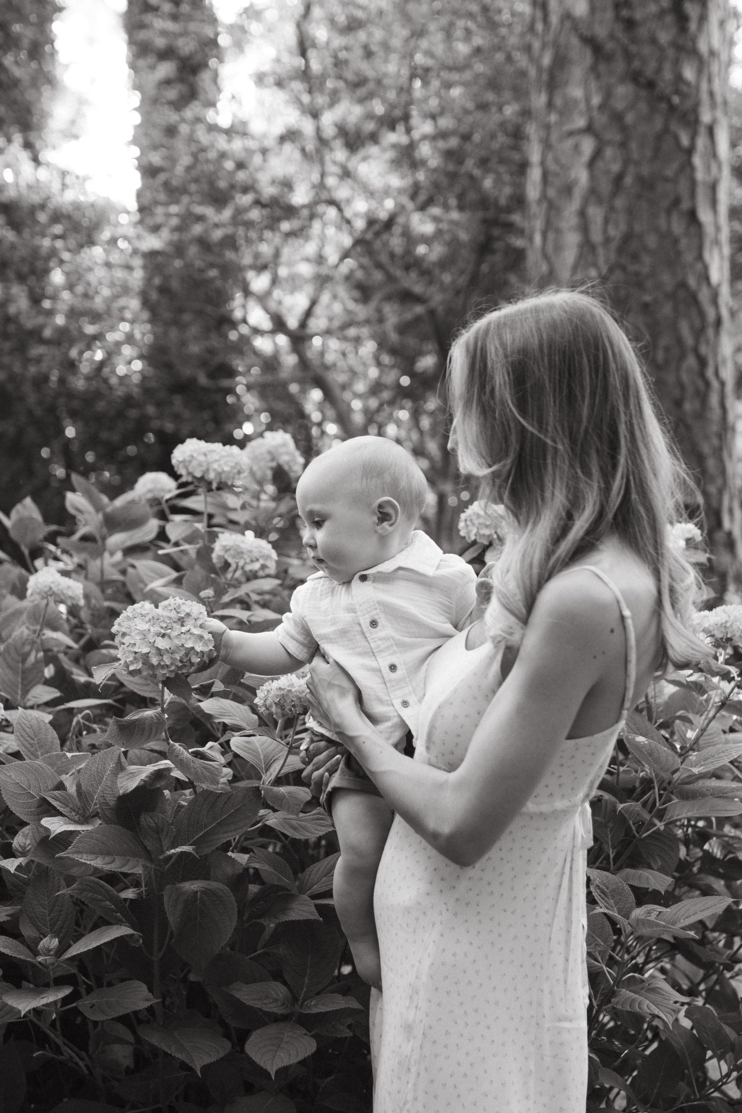 Mother and baby sharing a sweet, candid moment at glencairn gardens in rock hill