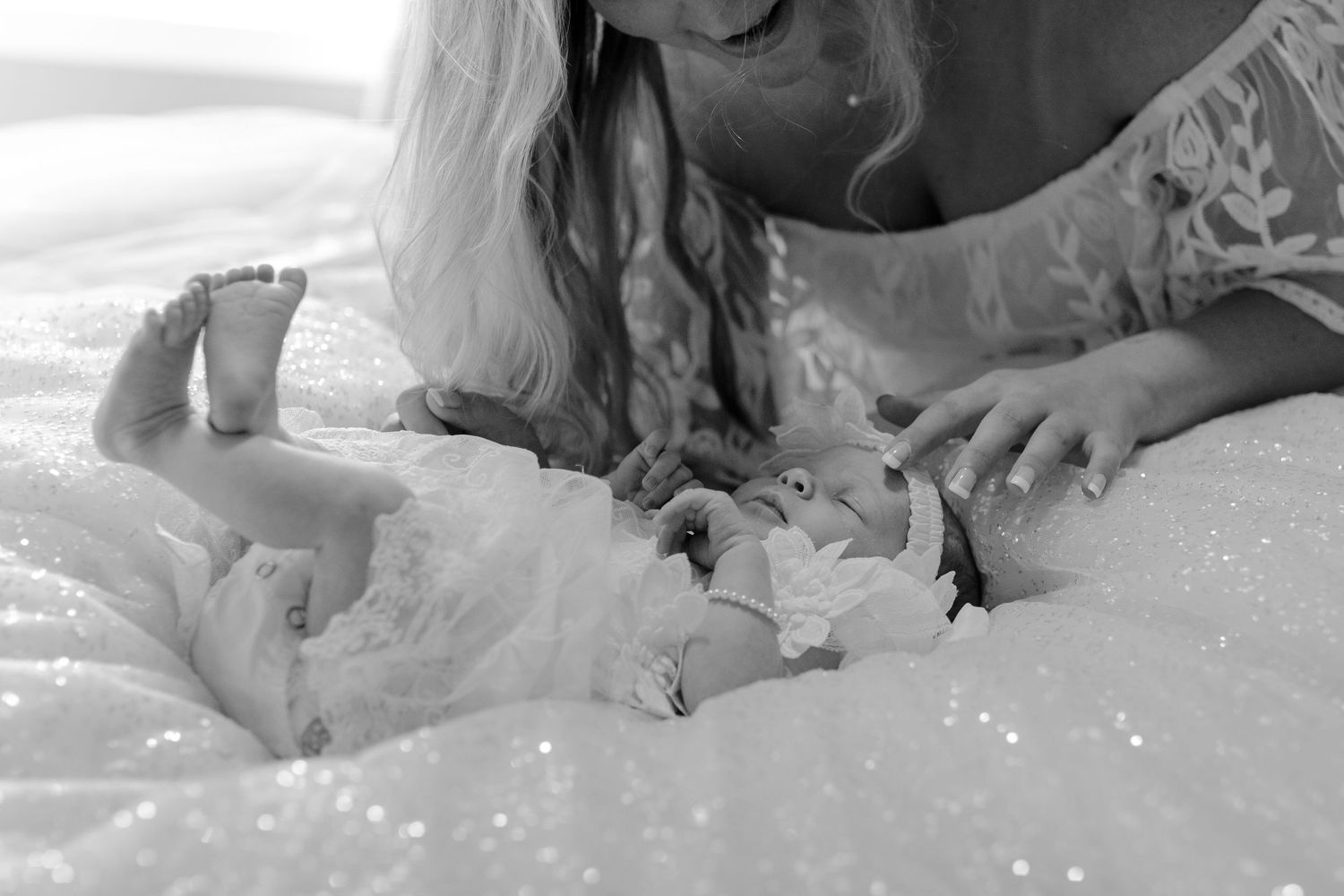 Mother gently holding her baby during a lifestyle newborn session
