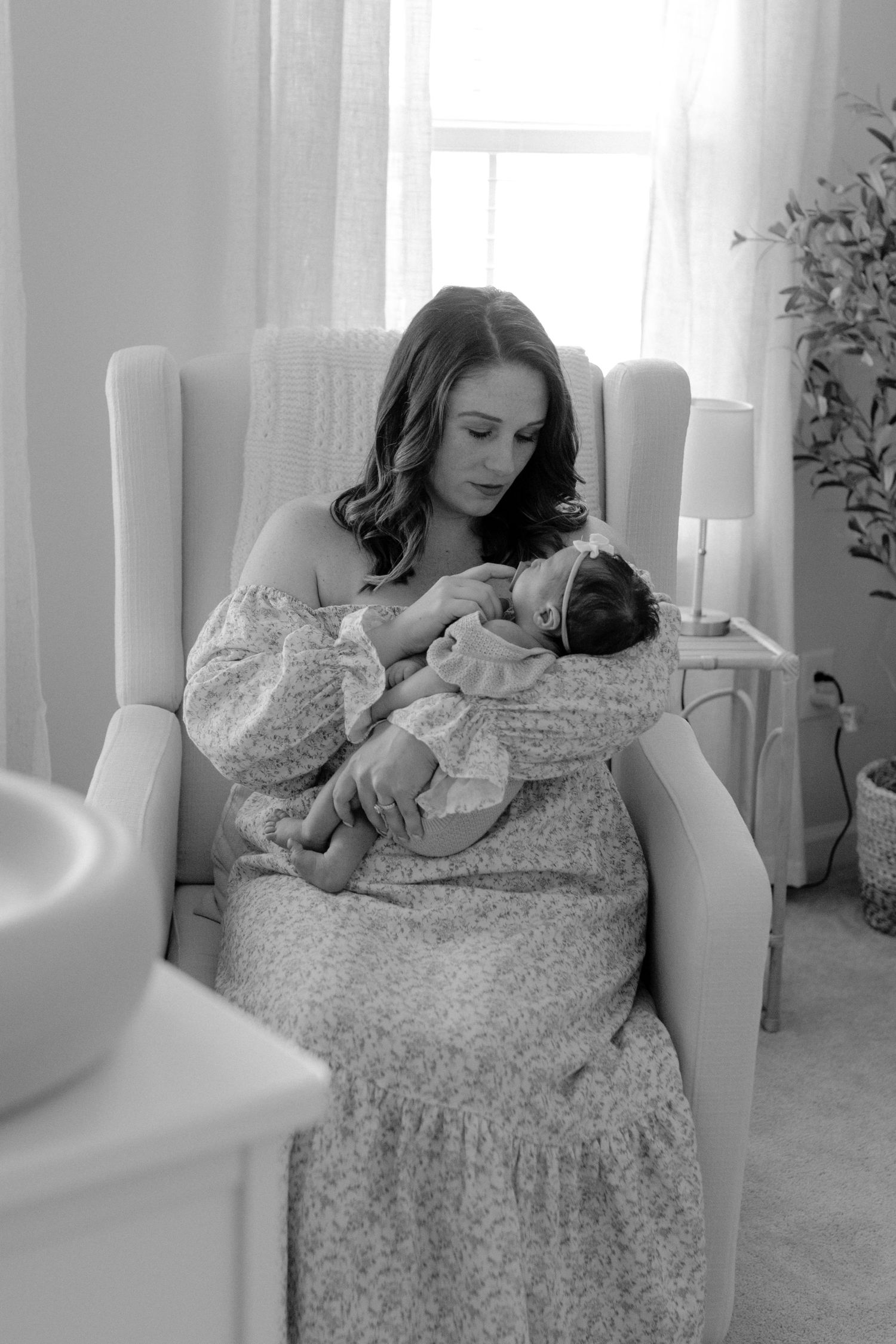 Mother gently holding her baby during a lifestyle newborn session in rock hill south carolina