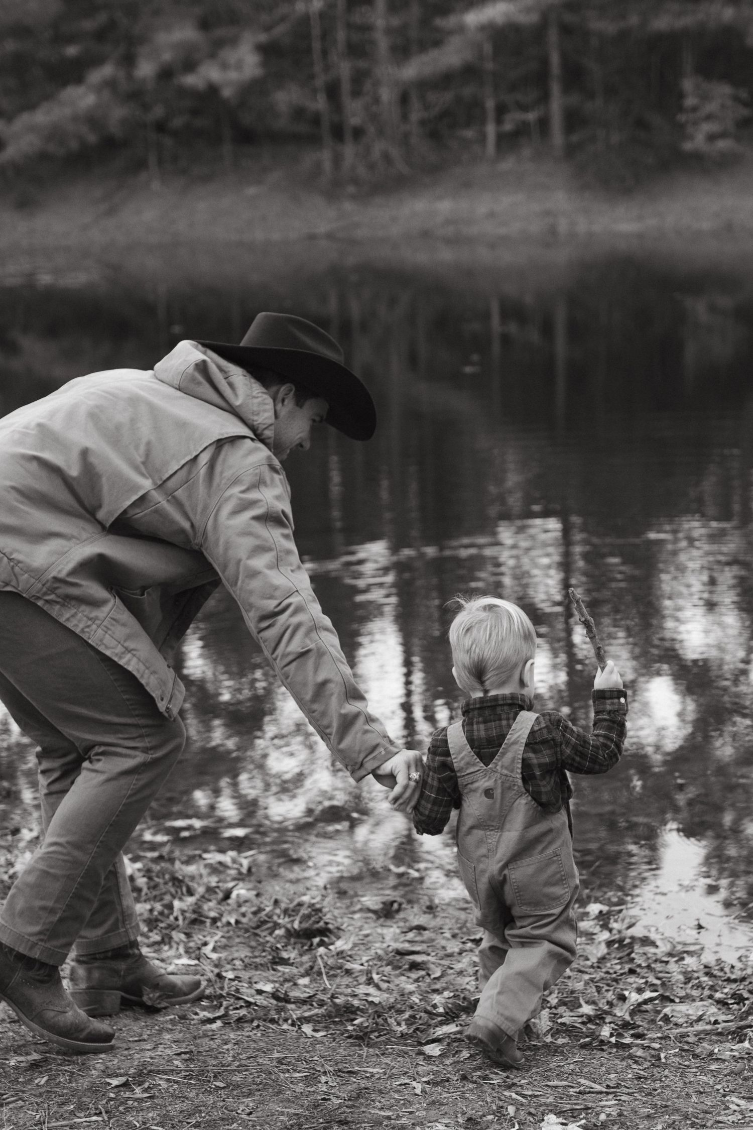 toddler boy fishing with dad at a pond in rock hill