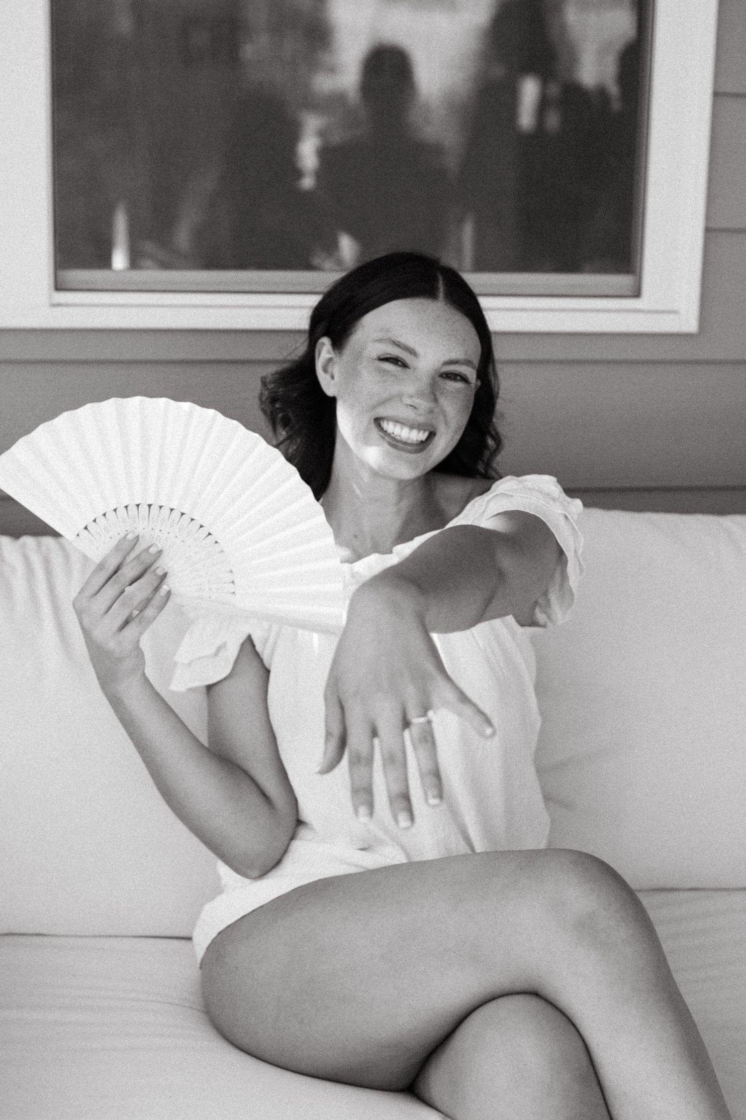 Bride fanning herself and showing her wedding ring