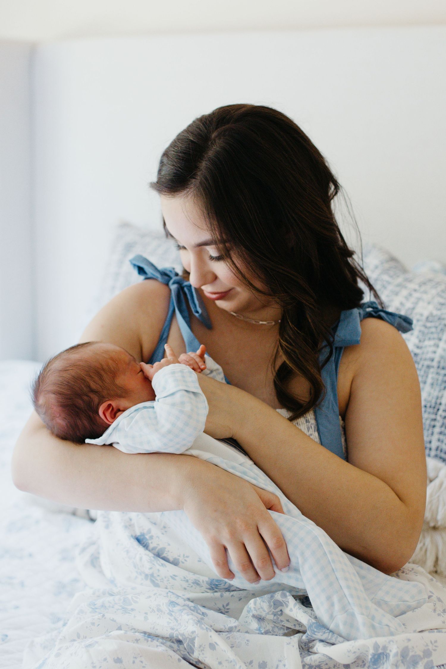 Mother gently holding her baby during a lifestyle newborn session
