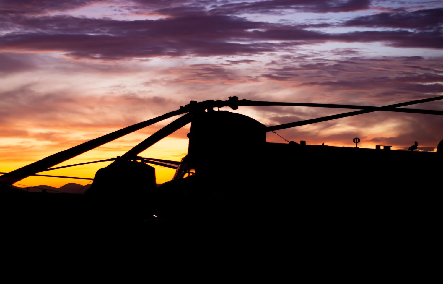 CH-47F Chinook Helicopter back lit by sunset
