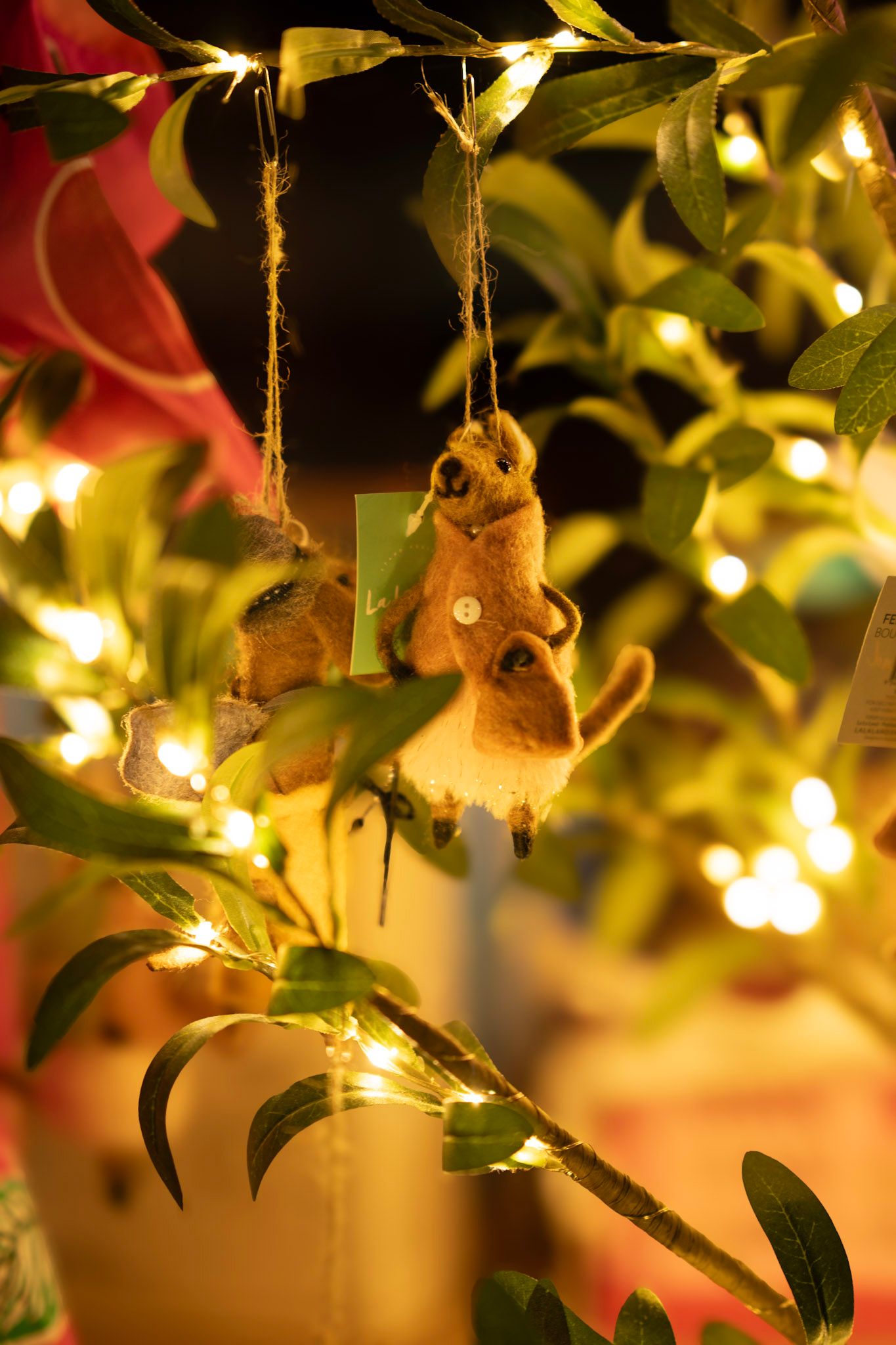 Felt christmas decoration hanging in backlit window