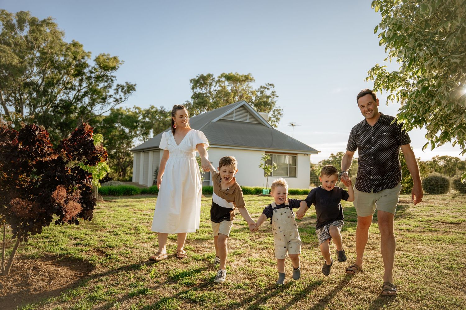Young family walking in garden