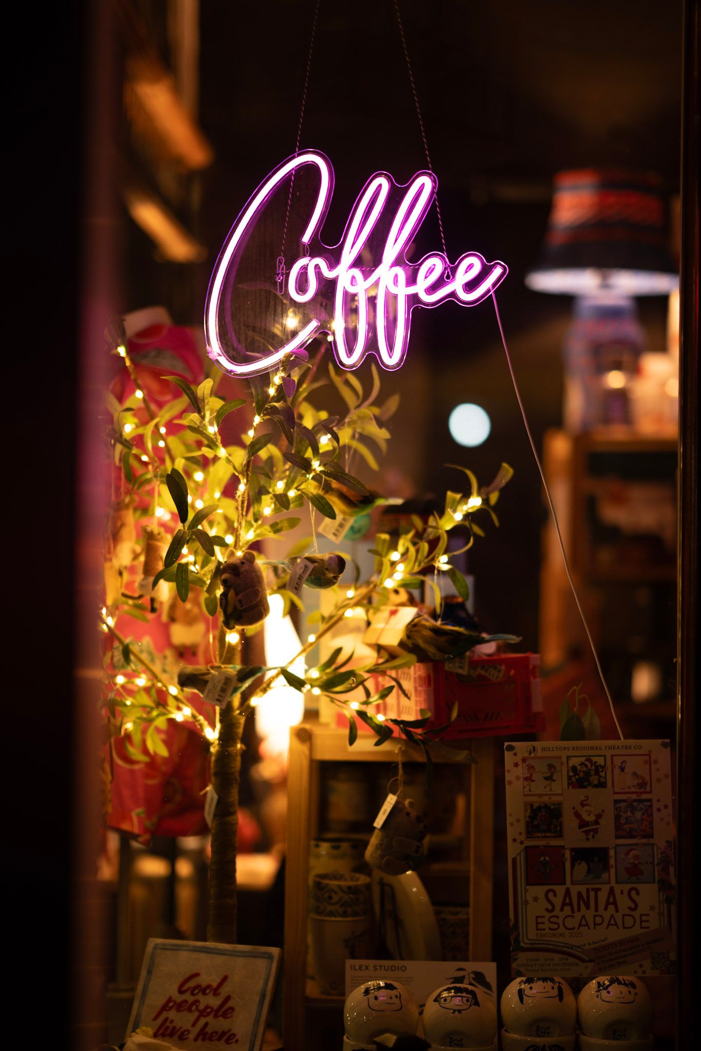 Neon coffee sign in shop window at night