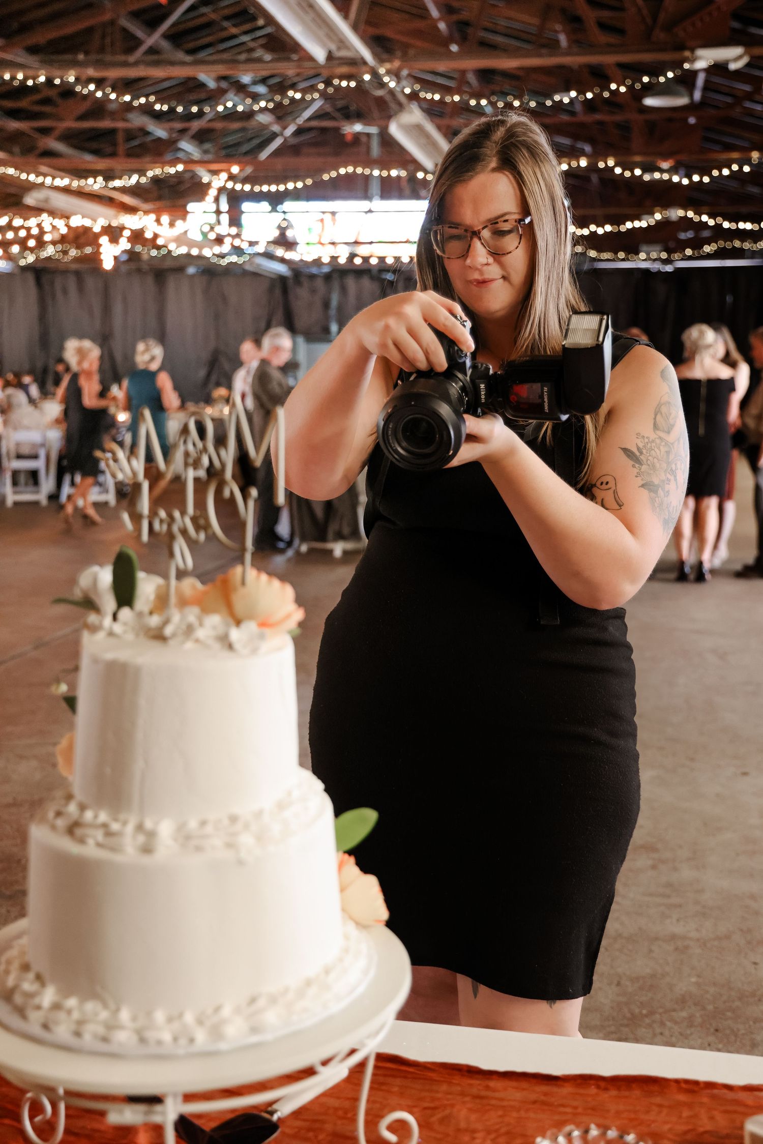 Wedding photographer capturing a wedding cake photo