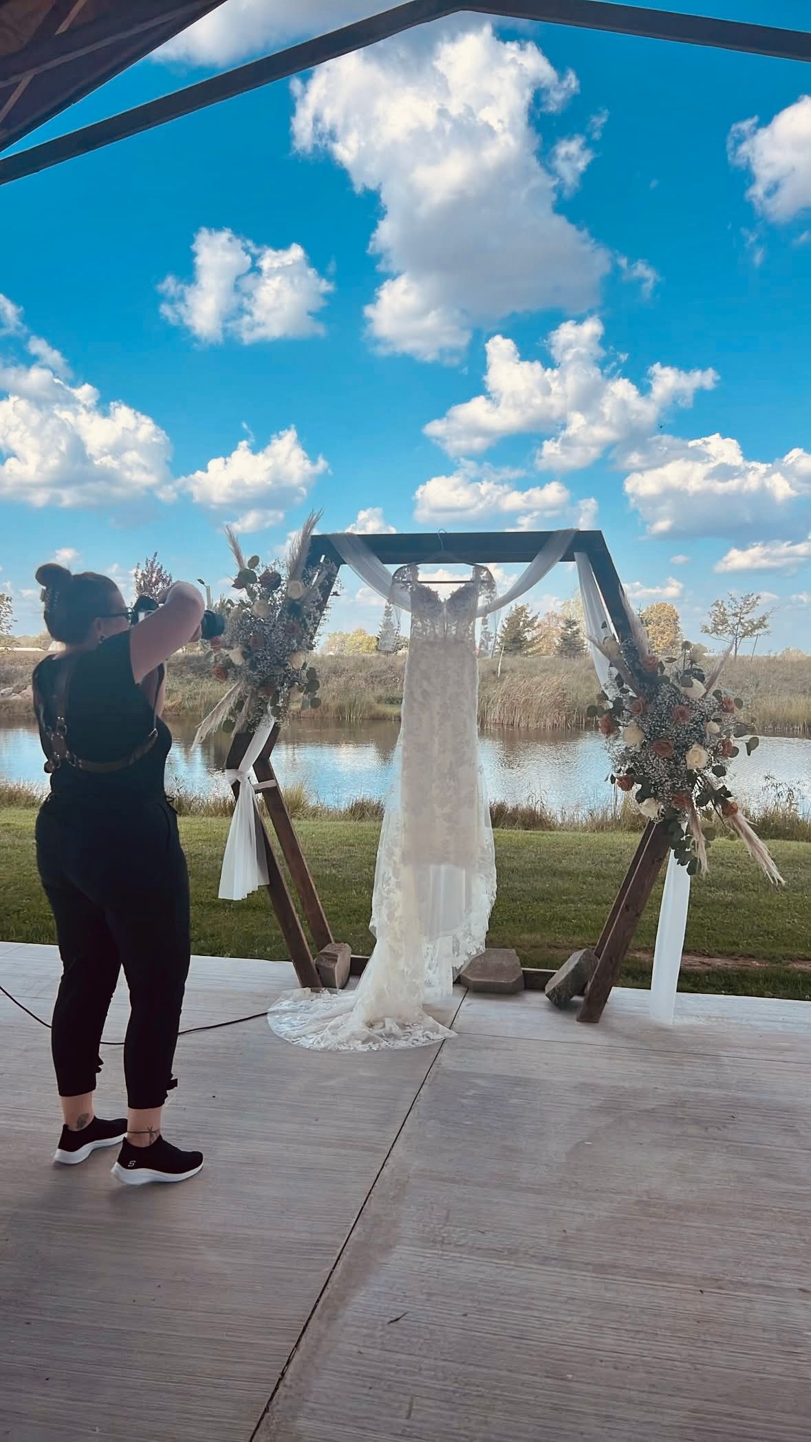photographer capturing image of wedding dress