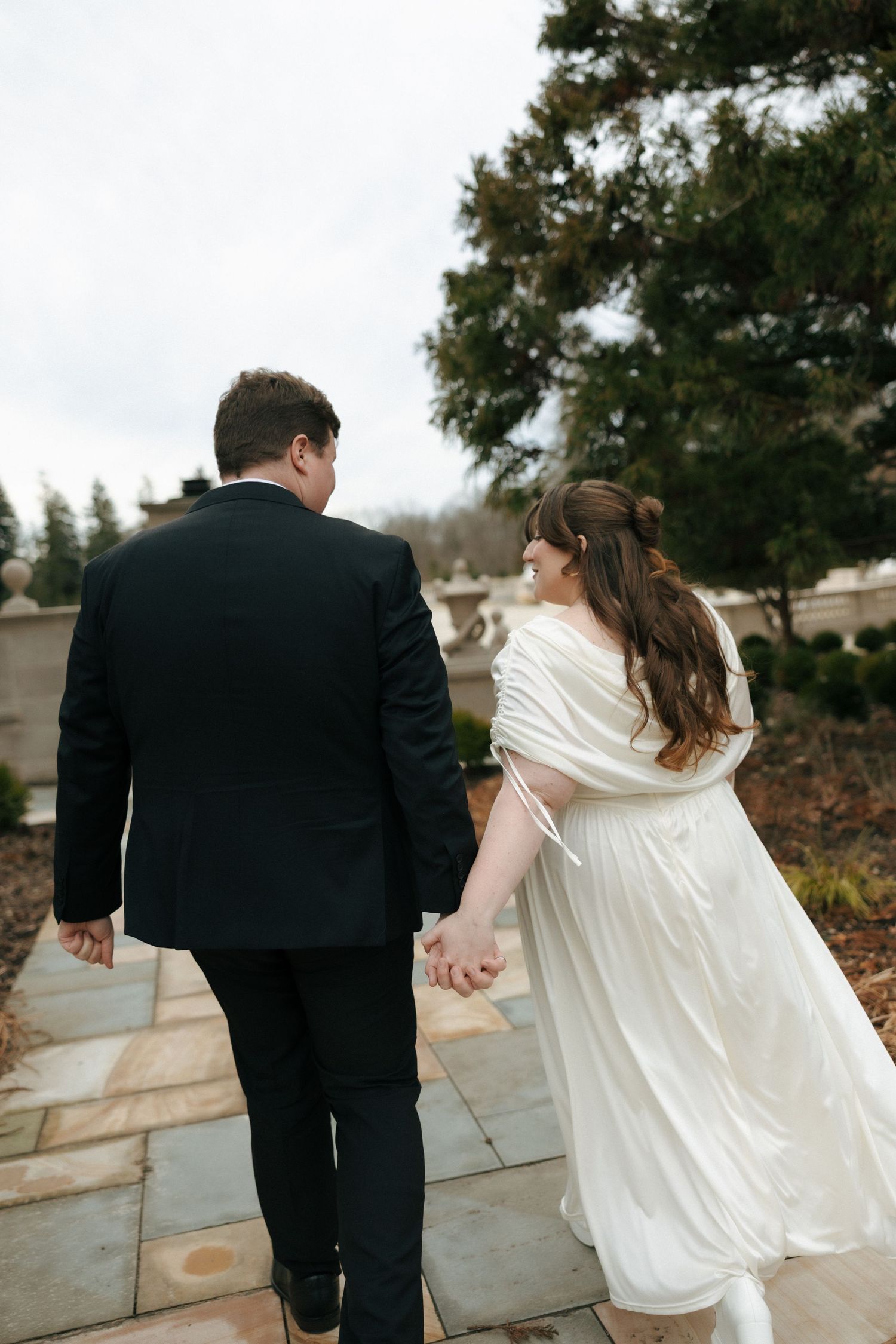 A couple in wedding attire holding hands while walking away, shown in a series of connected photos.