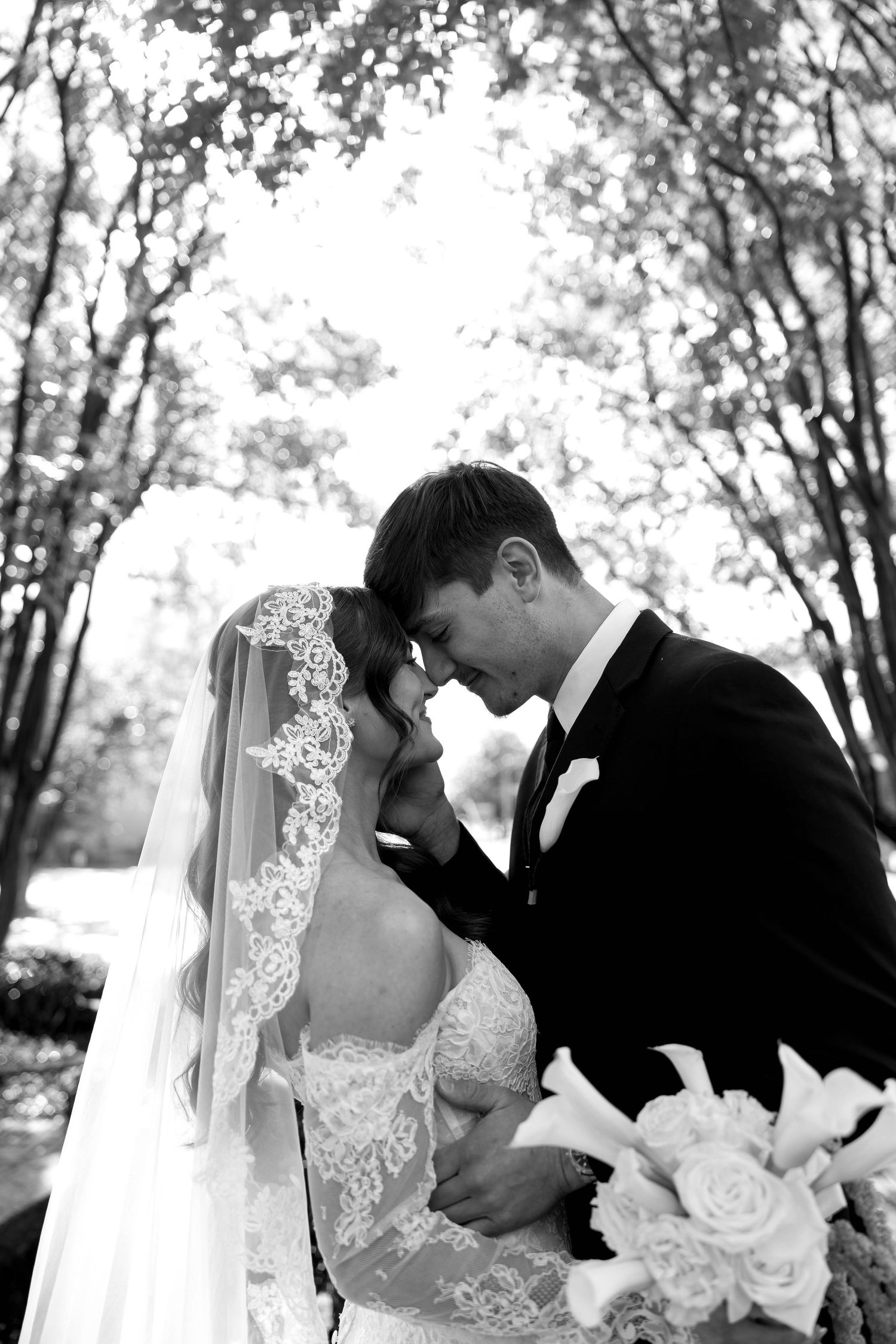 A black and white wedding photo collage showing three romantic dips and kisses between the couple.