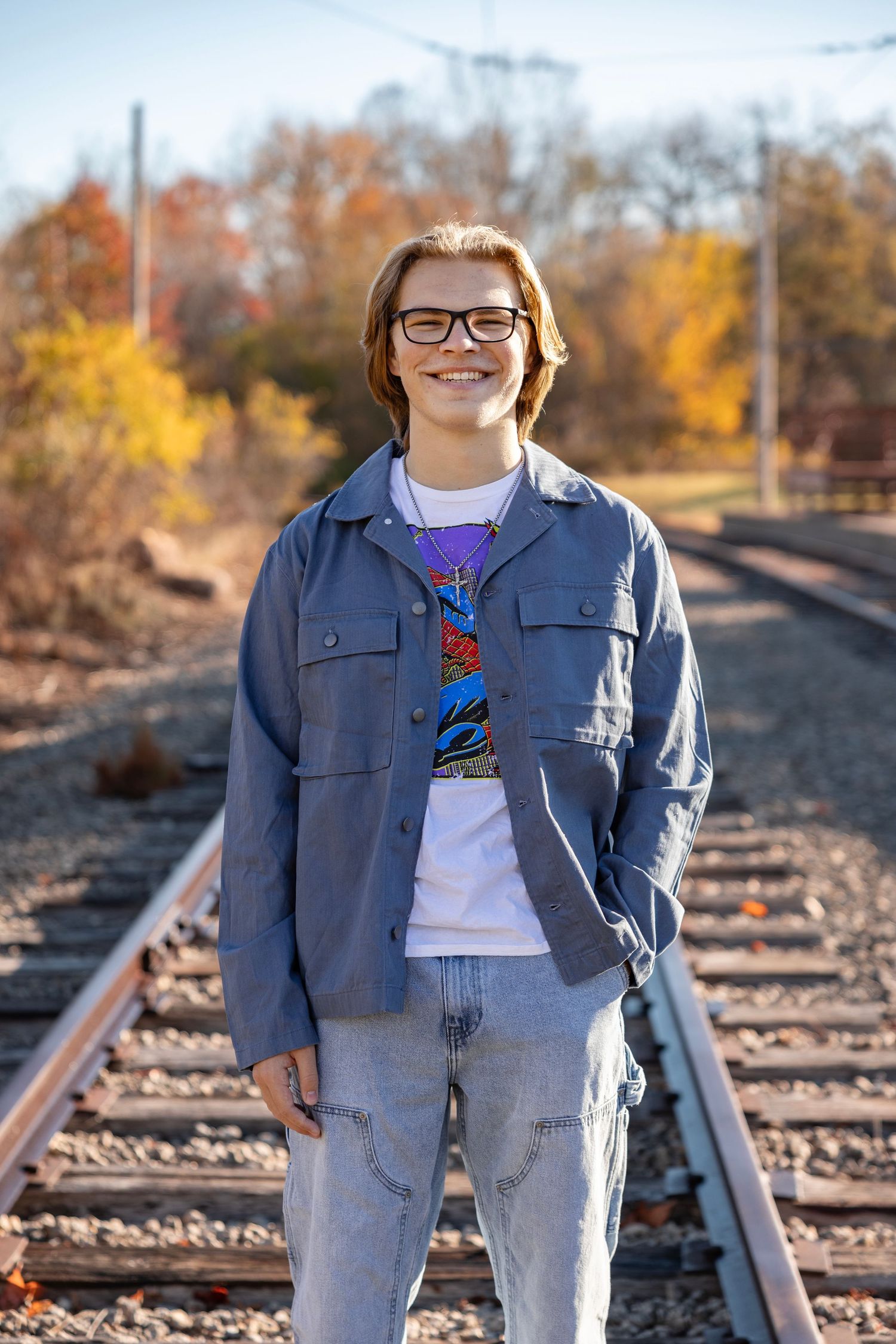 A high school senior session outdoors at Jon Duerr Forest Preserve in South Elgin, IL, featuring the senior surrounded b
