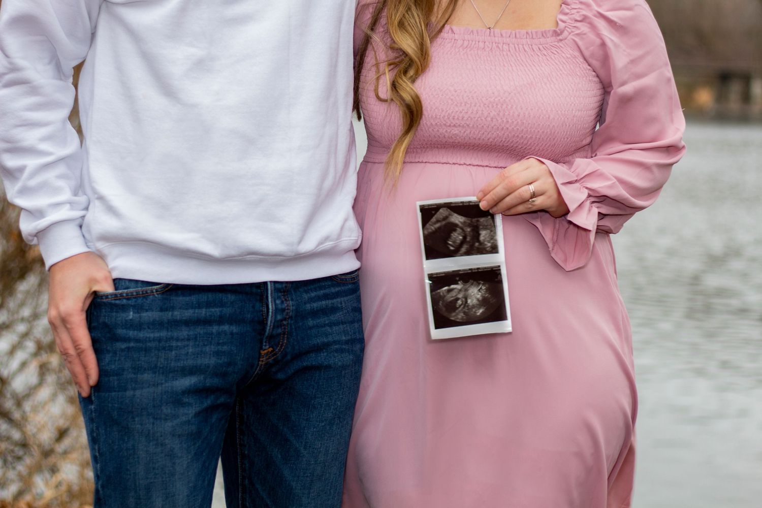 A heartfelt maternity session in St. Charles, IL, featuring a couple holding a sonogram over the expectant mother's bell