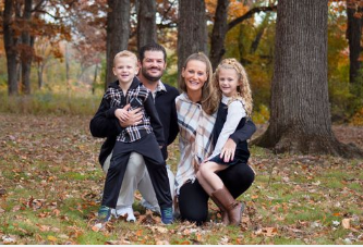 Cozy family photoshoot captured in the fall in South Elgin, IL, featuring parents and children surrounded by vibrant aut