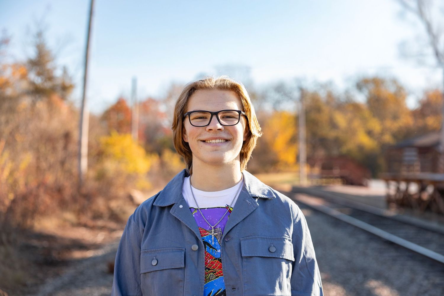 High school senior portrait session captured in Wheaton, IL, featuring a confident student posing outdoors with natural