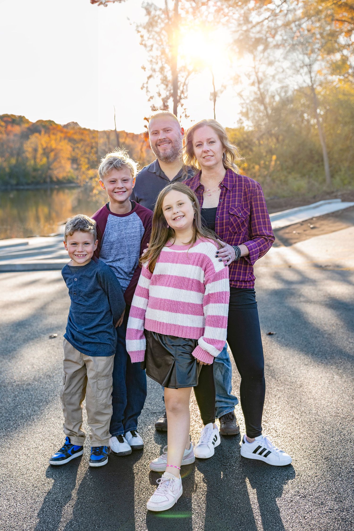 Casual family photo captured during golden hour in Geneva, IL, featuring warm sunlight and a natural outdoor setting, hi