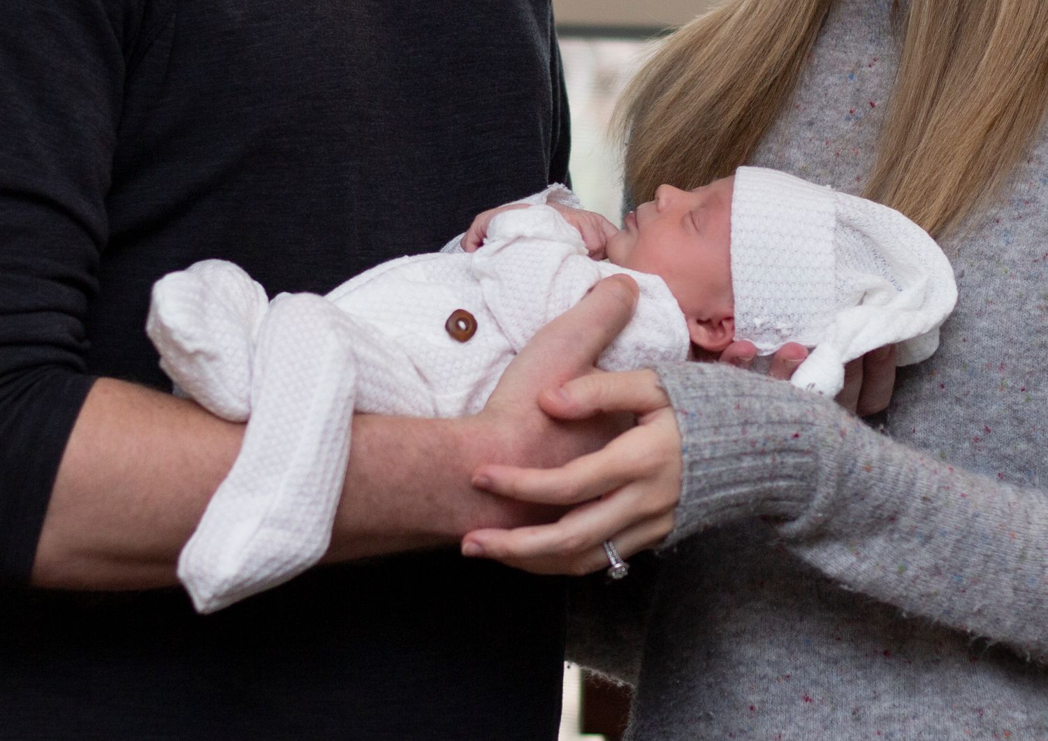 A heartwarming newborn lifestyle session captured in the comfort of their Chicagoland home, highlighting tender moments