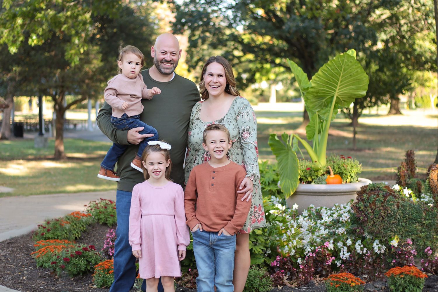 Heartfelt family portrait taken during an outdoor photography session in Wheaton, IL, featuring parents and children in