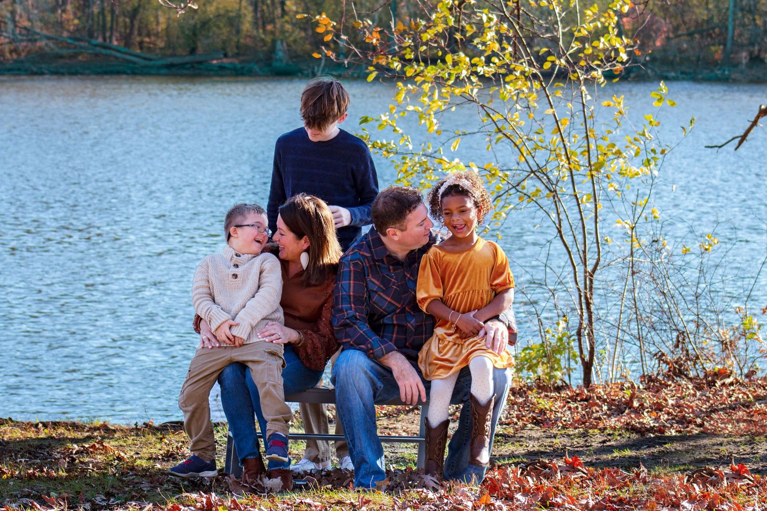 A beautiful family enjoying the outdoors, filled with laughter and smiles, surrounded by lush greenery and a warm, natur