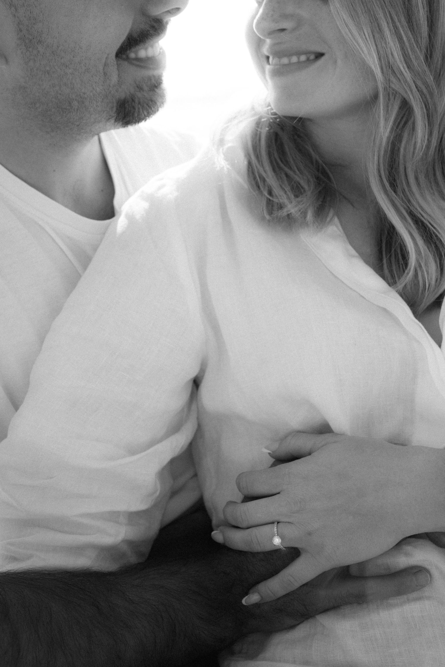 Black and white romantic couple photos showing tender intimate moments in white shirts.
