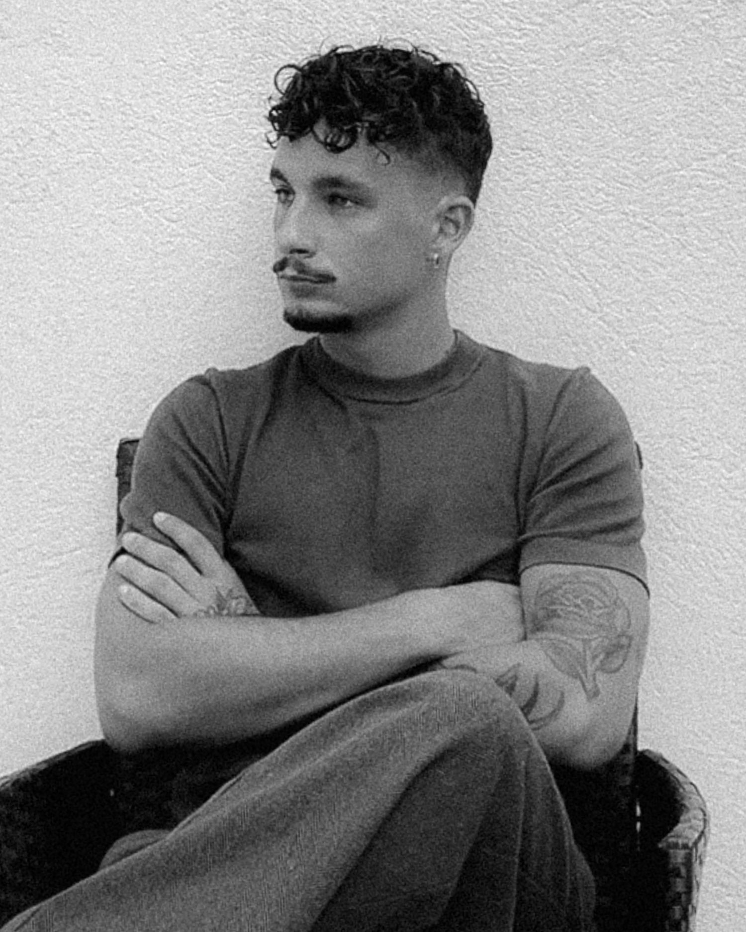 Black and white portrait series showing contemplative poses against a light background.